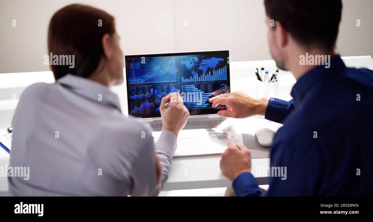 Two Analyst Using KPI Dashboard On Laptop Computer Stock Photo