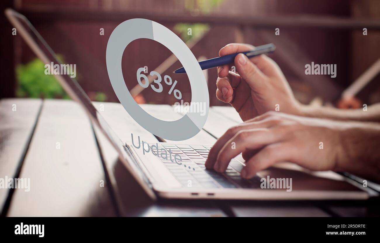 Man using laptop at the table. update the operating system to a newer one. Systems engineer Stock Photo