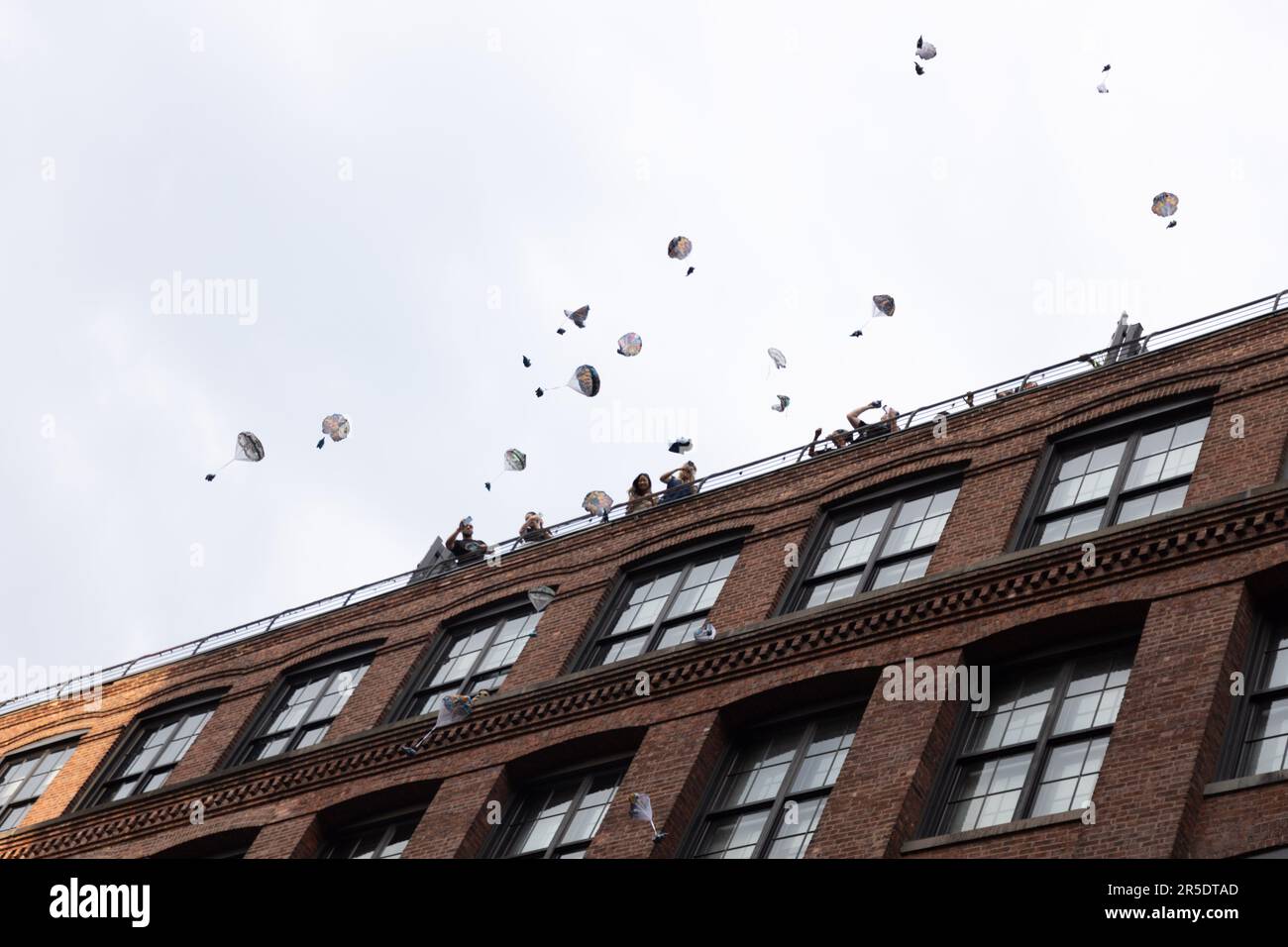 Toy elephants attached to a mini parachute are dropped from high above buildings on Washington Street in the Dumbo neighborhood of Brooklyn. The event is part of New York City's summer festivities calendar where it promotes the Dumbo neighborhood of Brooklyn. June 2, 2023 (Photo: Vanessa Carvalho) Credit: Brazil Photo Press/Alamy Live News Stock Photo