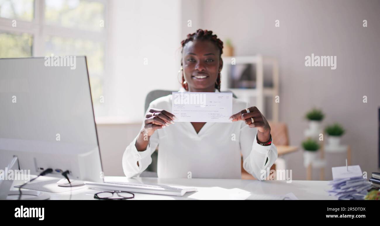 Holding Paycheck Or Payroll Check Or Insurance Cheque In Hand Stock