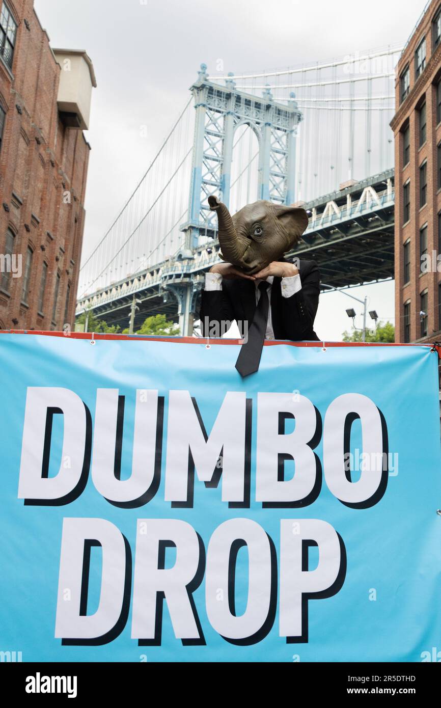 Toy elephants attached to a mini parachute are dropped from high above buildings on Washington Street in the Dumbo neighborhood of Brooklyn. The event is part of New York City's summer festivities calendar where it promotes the Dumbo neighborhood of Brooklyn. June 2, 2023 (Photo: Vanessa Carvalho) Credit: Brazil Photo Press/Alamy Live News Stock Photo