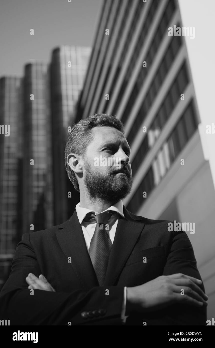Portrait of businessman standing in a office. Entrepreneur, business portrait. Businessman standing proud with arms crossed outside Stock Photo