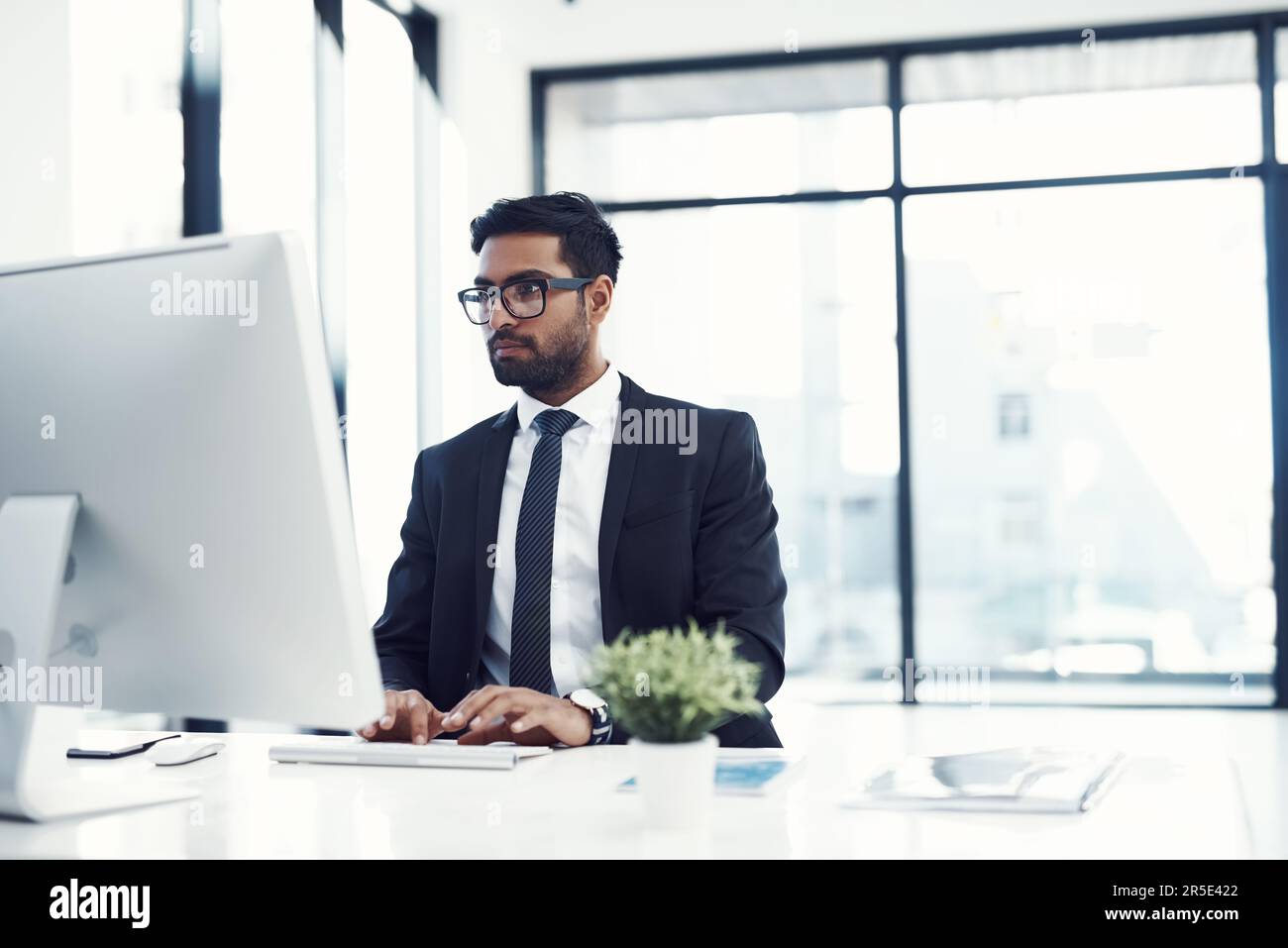 Take On Computer Take on the risk and reap the benefits. a young businessman working on ...