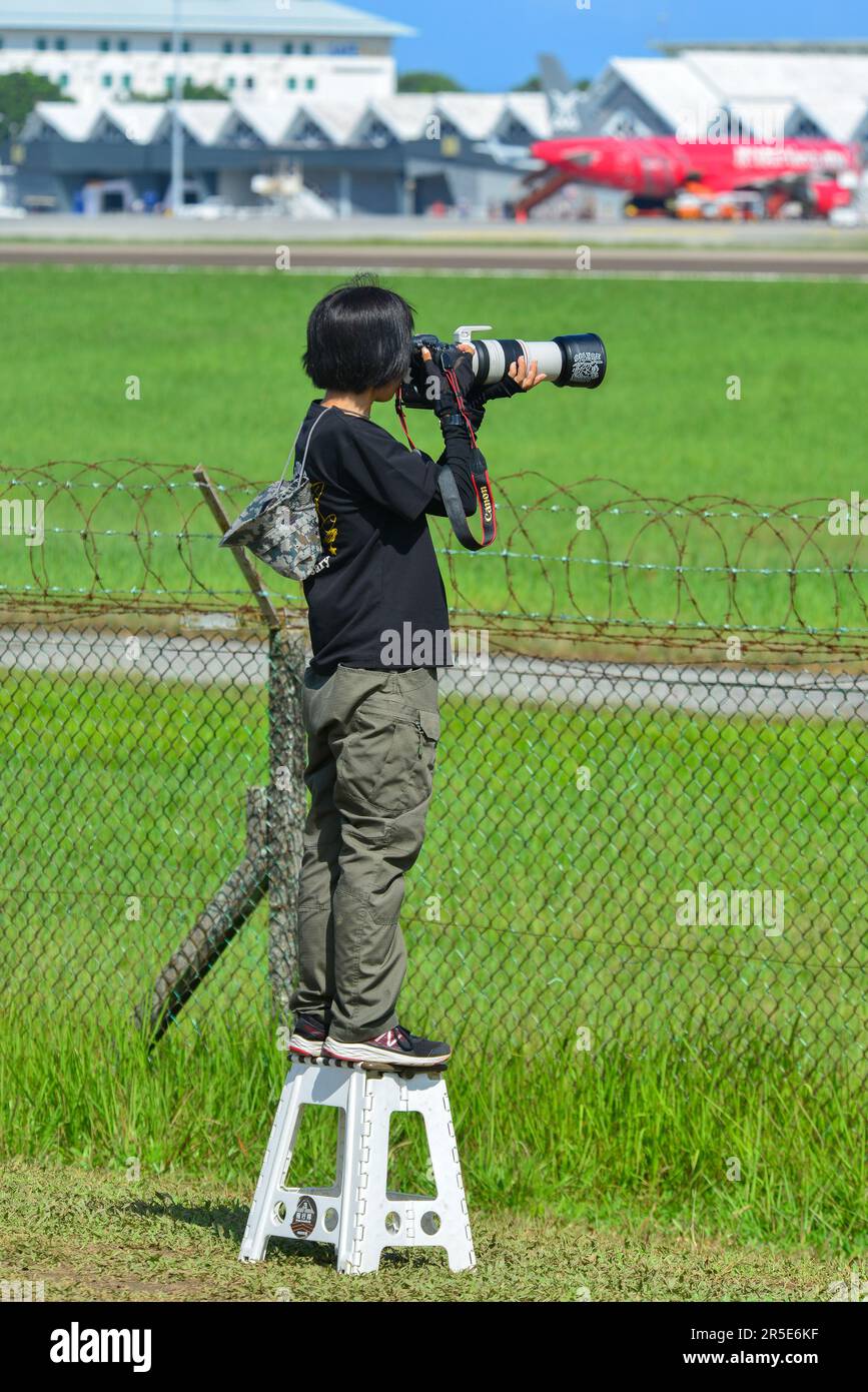 Langkawi, Malaysia - May 28, 2023. A foreign photographer waiting for taking pictures of airplanes at Langkawi Airport (LGK), Malaysia. Stock Photo