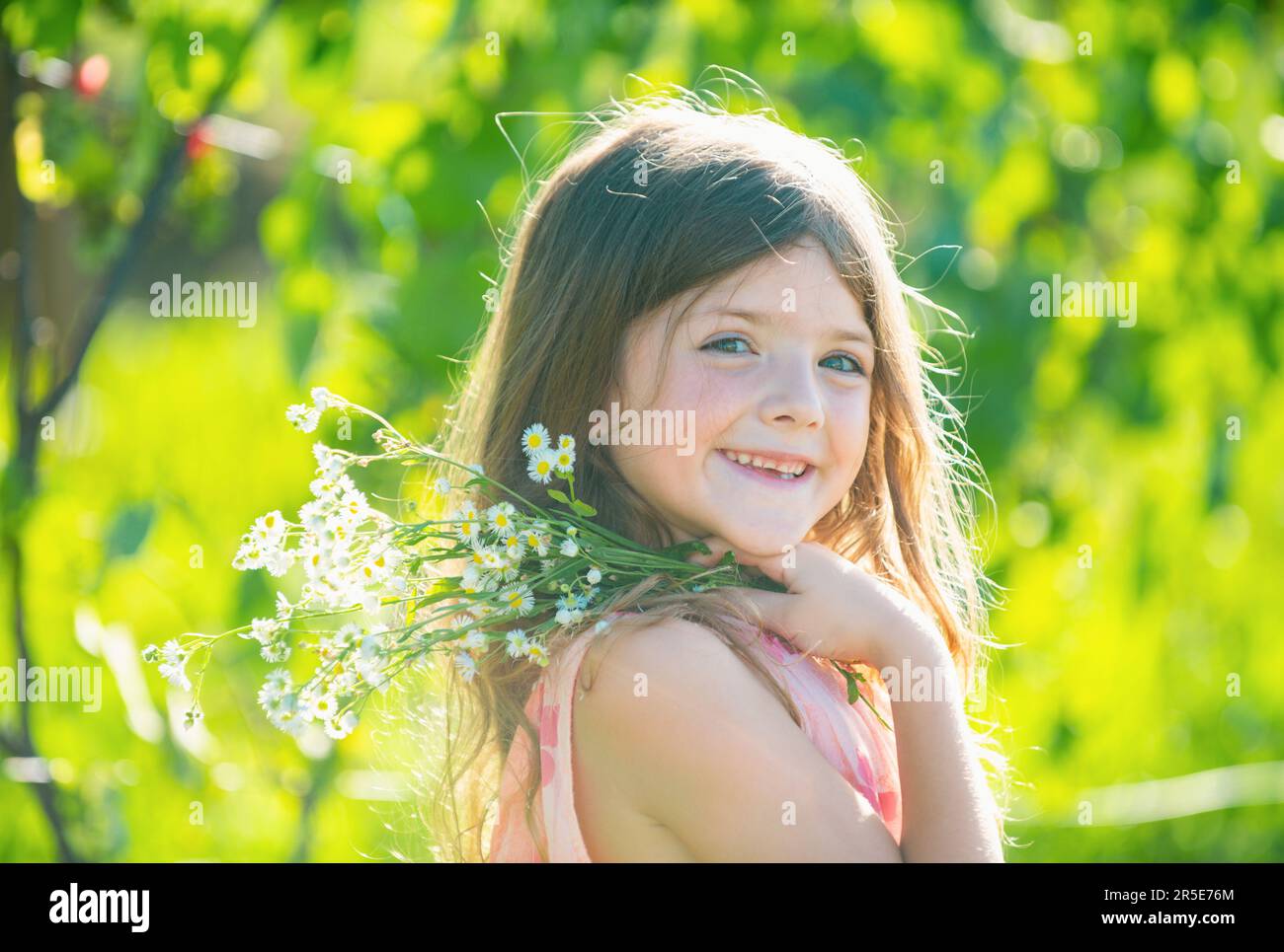 Outdoor small child girl portrait on the meadow. Little cute kid with ...