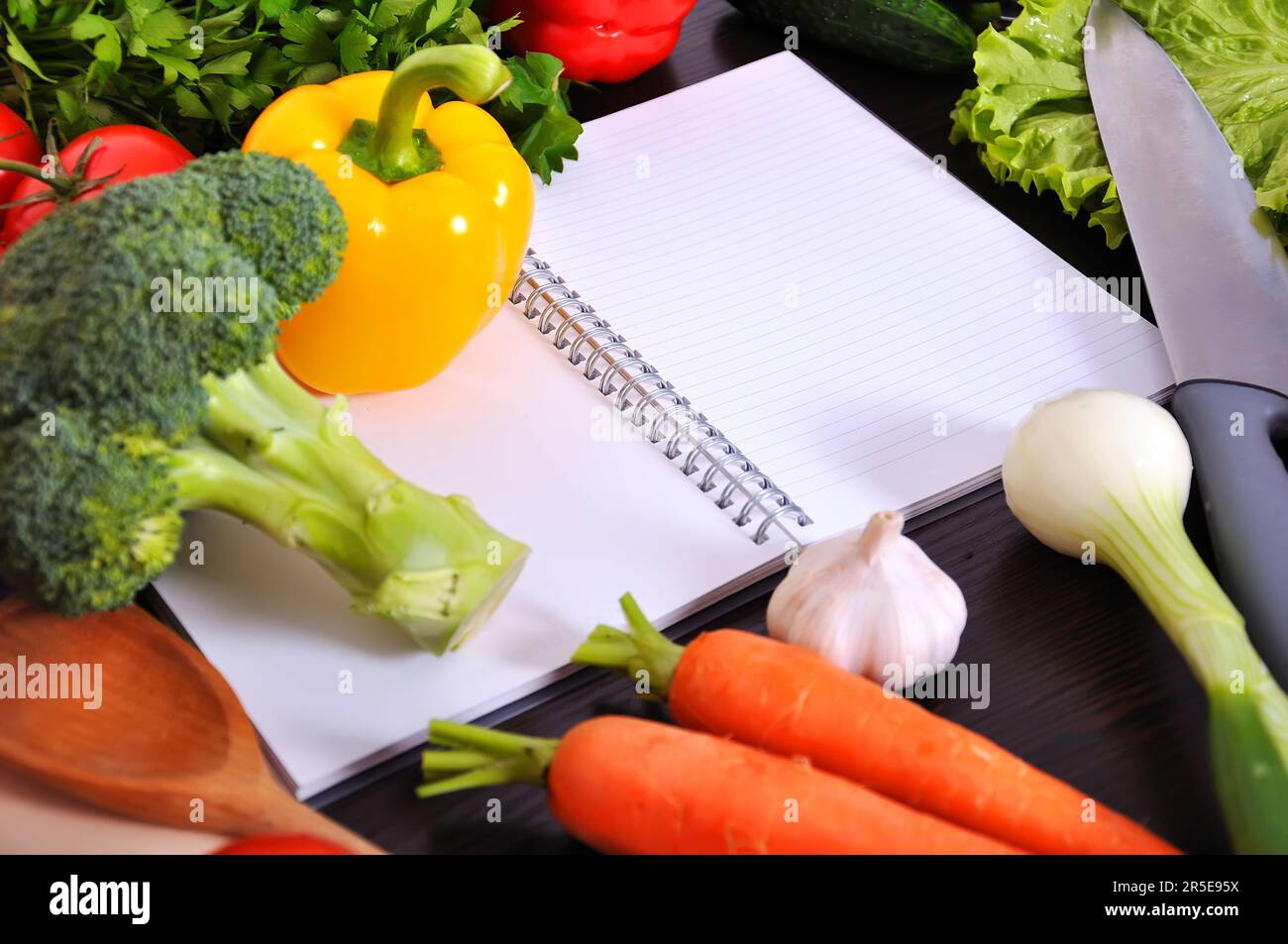 recipe book with vegetables on wooden table Stock Photo