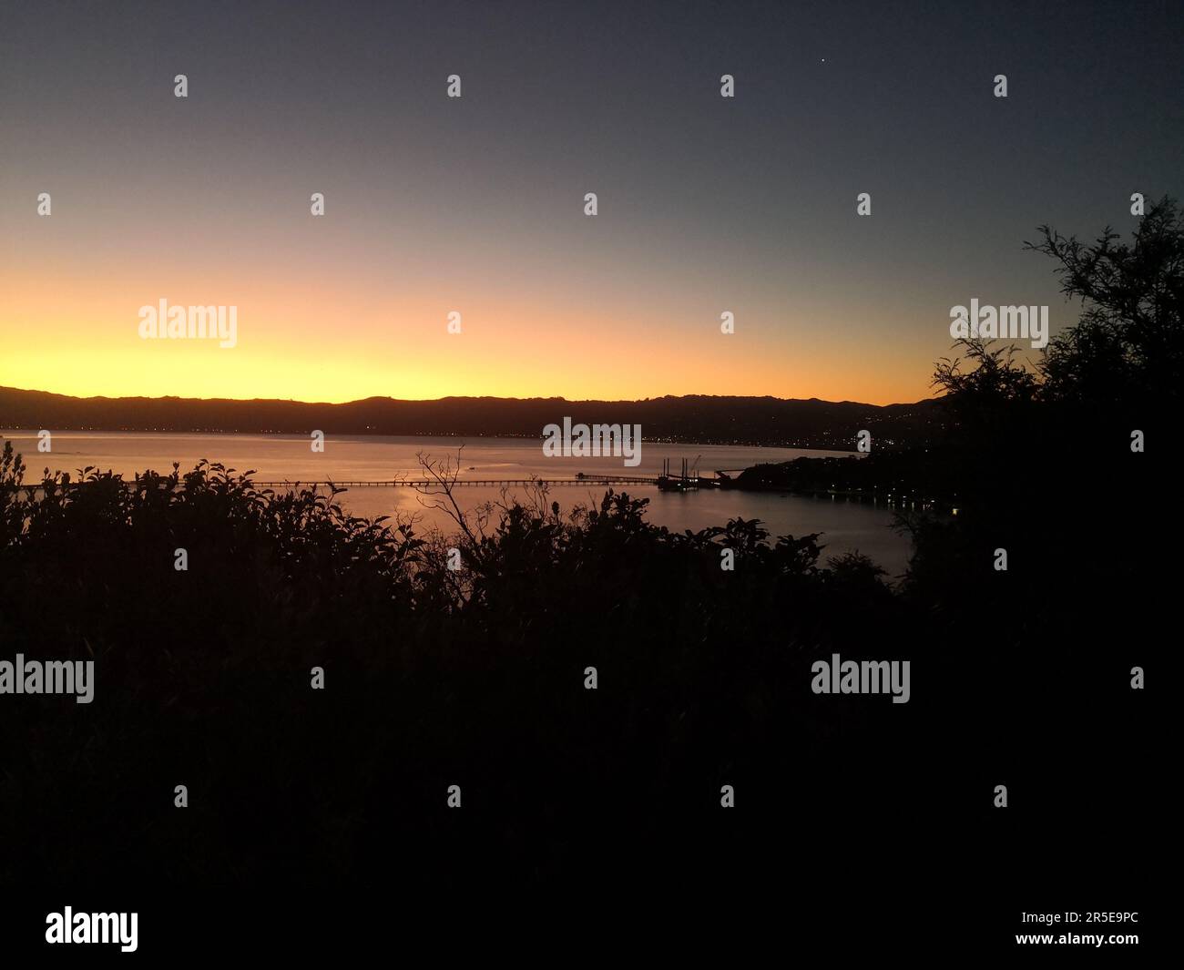 Sunset over Wellington Harbour in winter, New Zealand Stock Photo