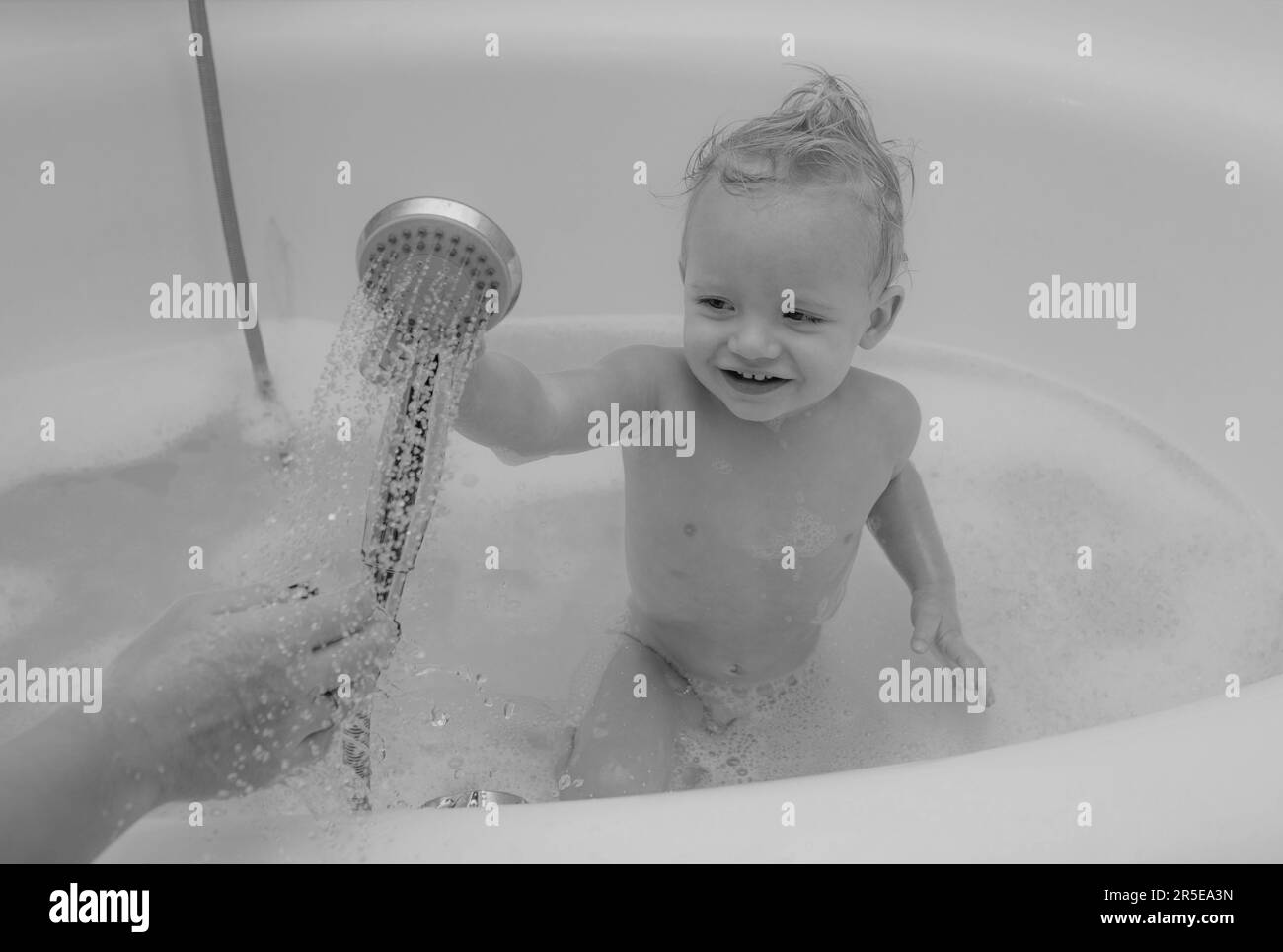 Happy baby face in bubble bath. Childs hygiene. Adorable baby with soap