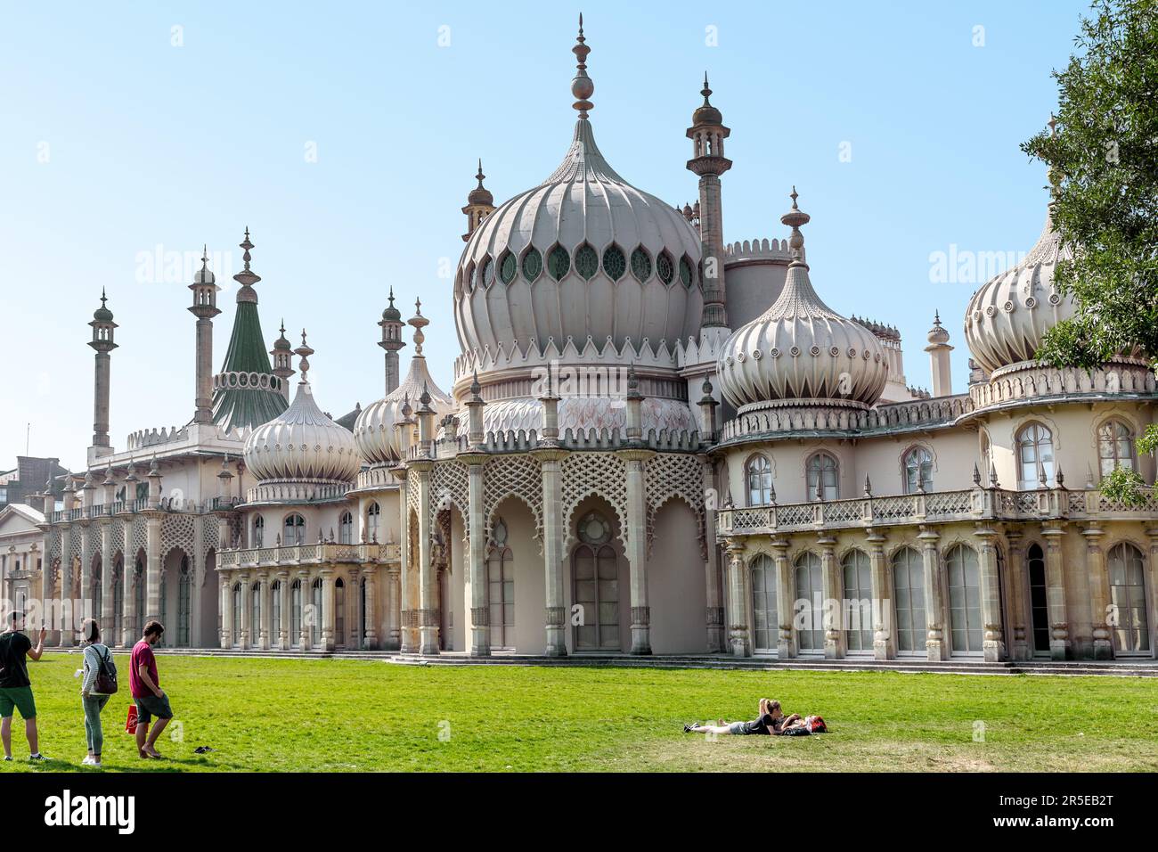 BRIGHTON, GREAT BRITAIN - SEPTEMBER 16, 2014: This is the lawn in front of the Royal Pavilion with people resting on the grass. Stock Photo