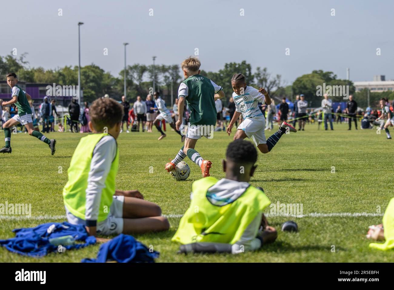Boys playing organised grassroots football and soccer in UK on sunny day. Stock Photo