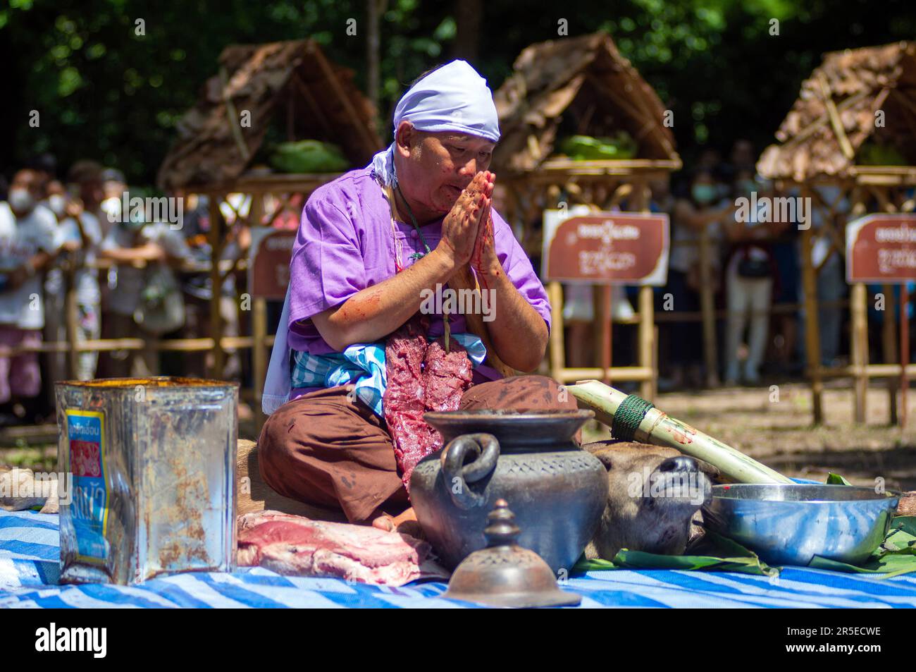 A Thai man involves ' medium ' salutes during the Pu Sae Ya Sae ...