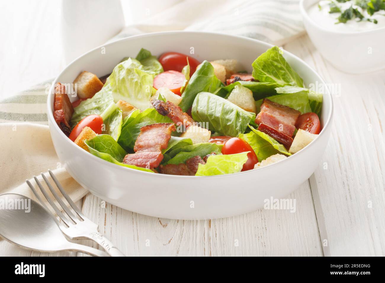 Healthy Organic BLT Bacon Salad with Lettuce and Tomato closeup on the plate on the table. Horizontal Stock Photo