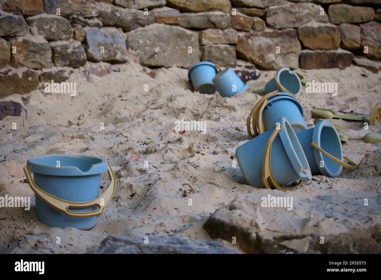 A set of pale blue buckets, partially filled with sand, on a beach Stock Photo Alamy