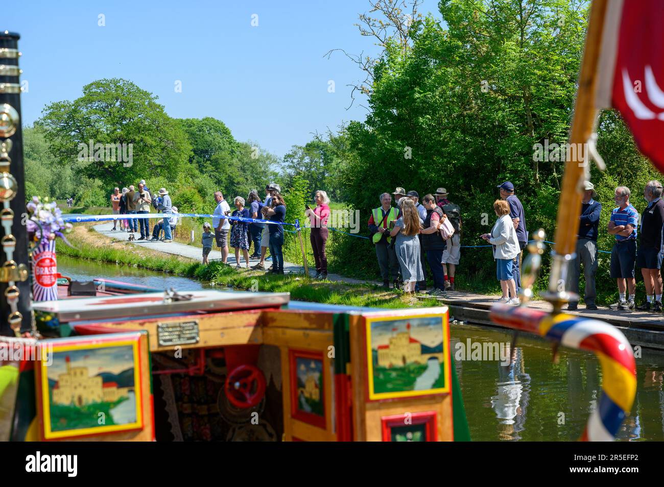 People on the canal towpath watching the official opening of the Crickheath Basin on the Montgomery Canal Stock Photo