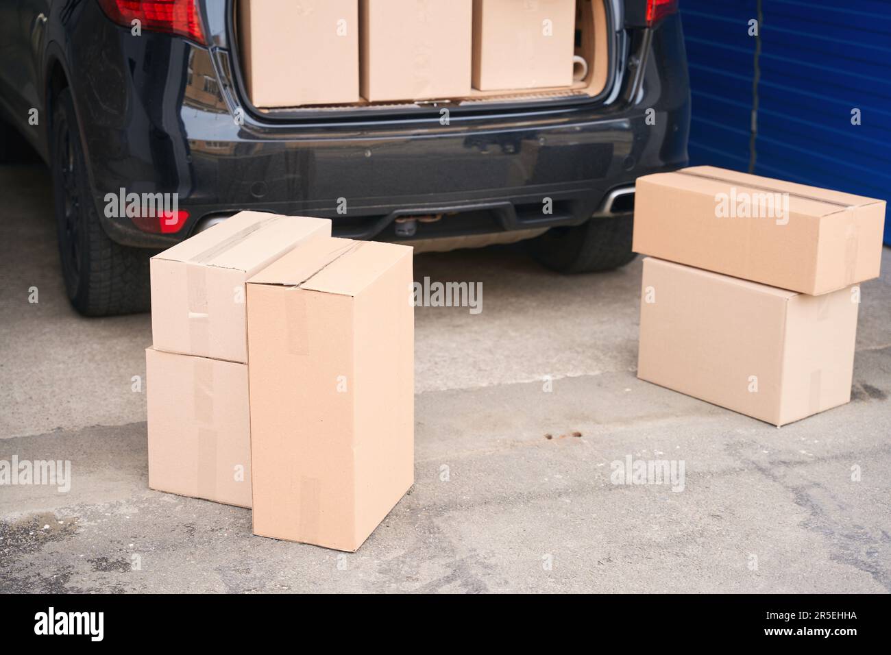 Car with cardboard boxes in the trunk in a warehouse with selfstorage unit Stock Photo Alamy