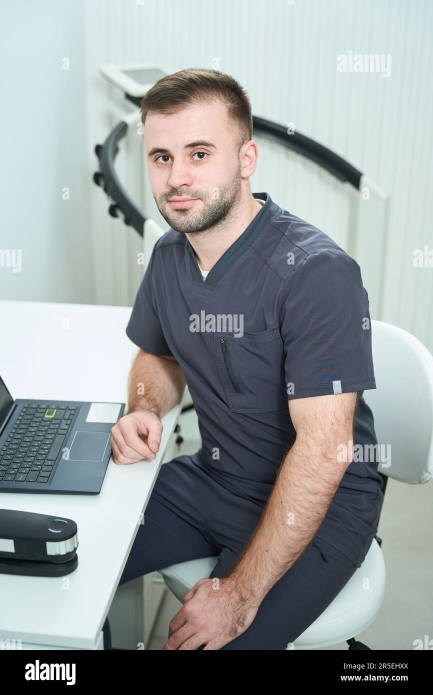 Young specialist nutritionist sits at his workplace at his desk Stock Photo