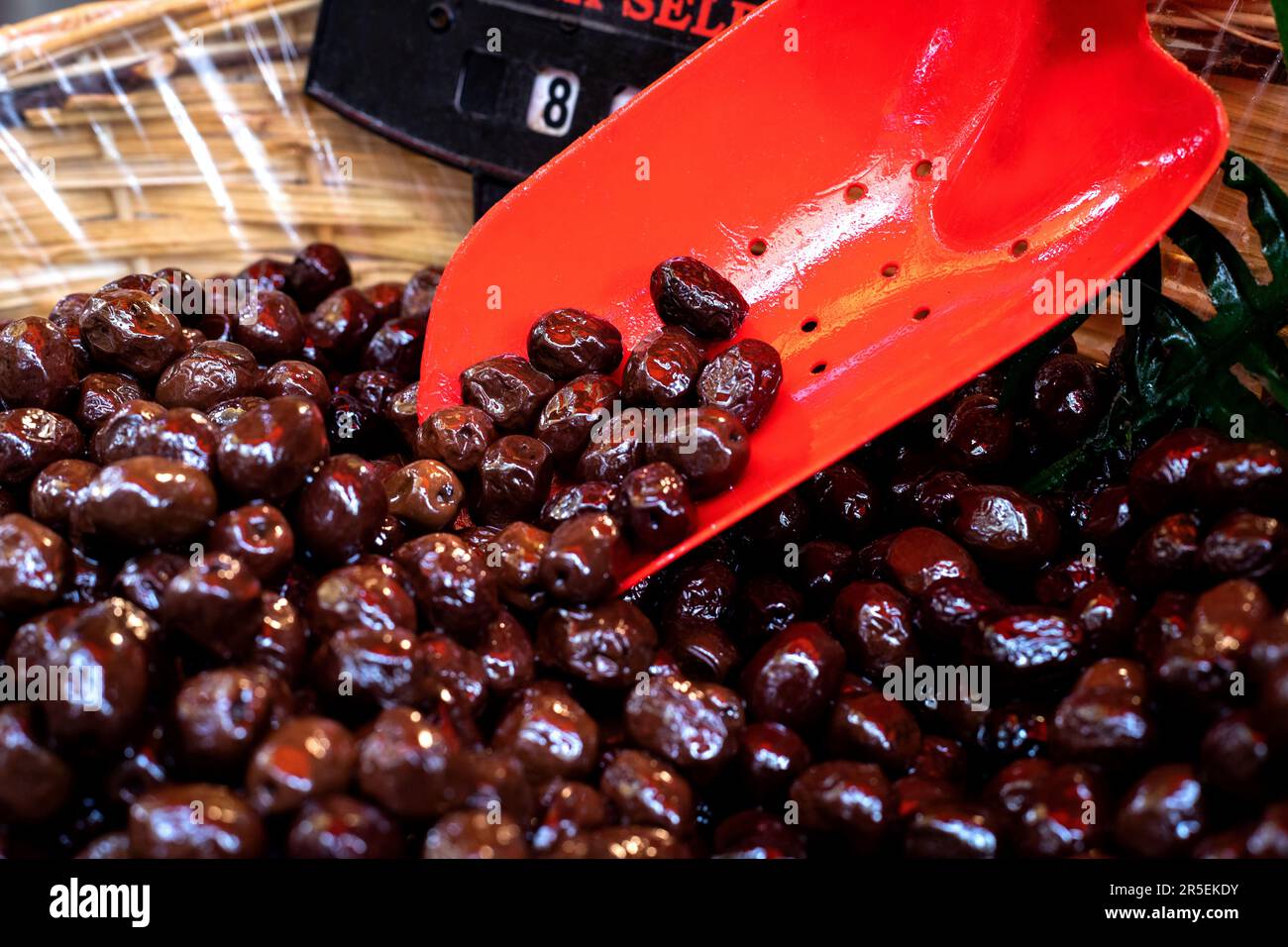 Stall with black olives at street market in Izmir, Türkiye. Ayvalik Sele Olives in the bazaar. Stock Photo