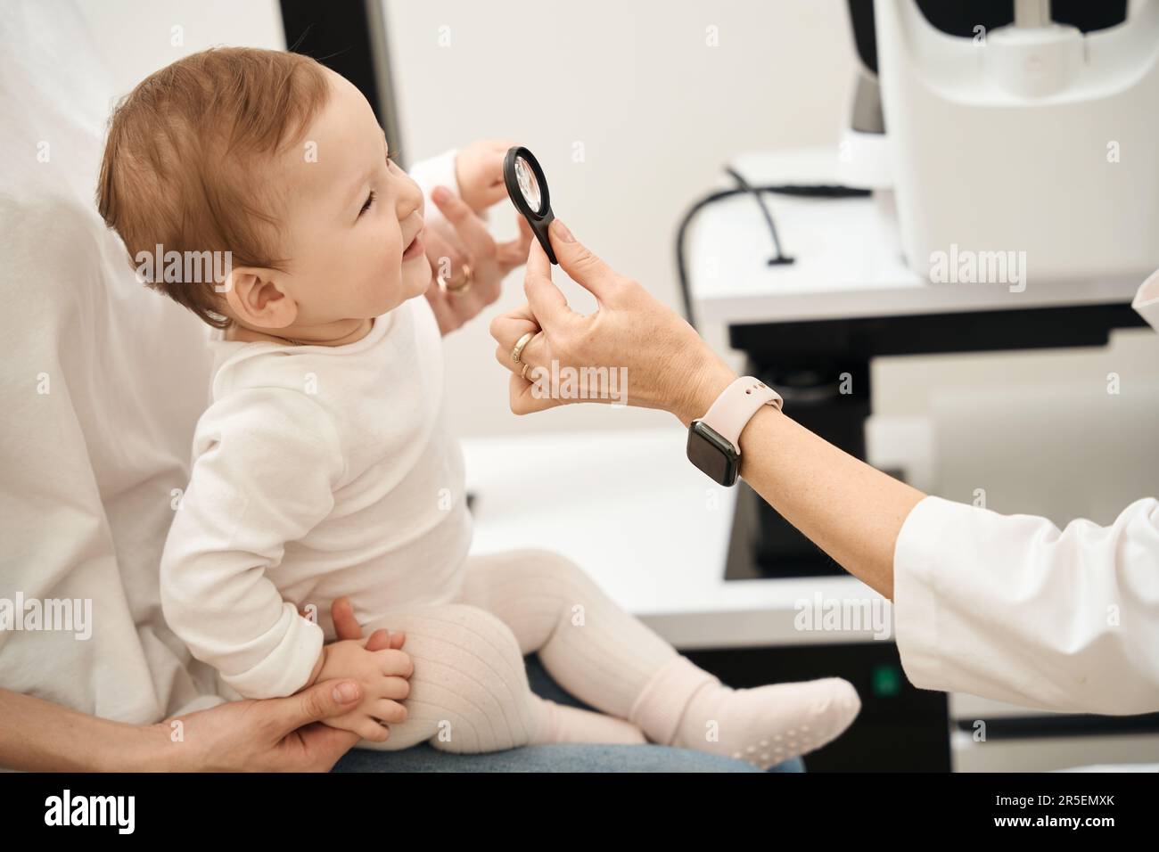 Pediatric oculist checking child vision during consultation Stock Photo