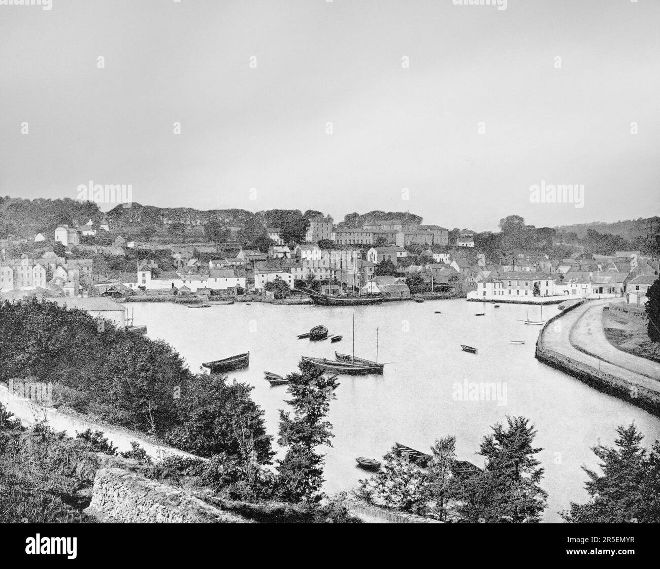 A late 19th century view of the harbour in Kinsale, a historic port and fishing town in County Cork, Ireland, the location of several battles. The most important being in 1601, when a Spanish military expedition  landed there to link with Irish rebel forces and attack England through Ireland. As a result, the battle of Kinsale took place at the end of the Nine Years War in which English forces  defeated the rebel Irish force, led by Hugh O'Neill, 2nd Earl of Tyrone and Red Hugh O'Donnell, two Gaelic princes from Ulster. Stock Photo