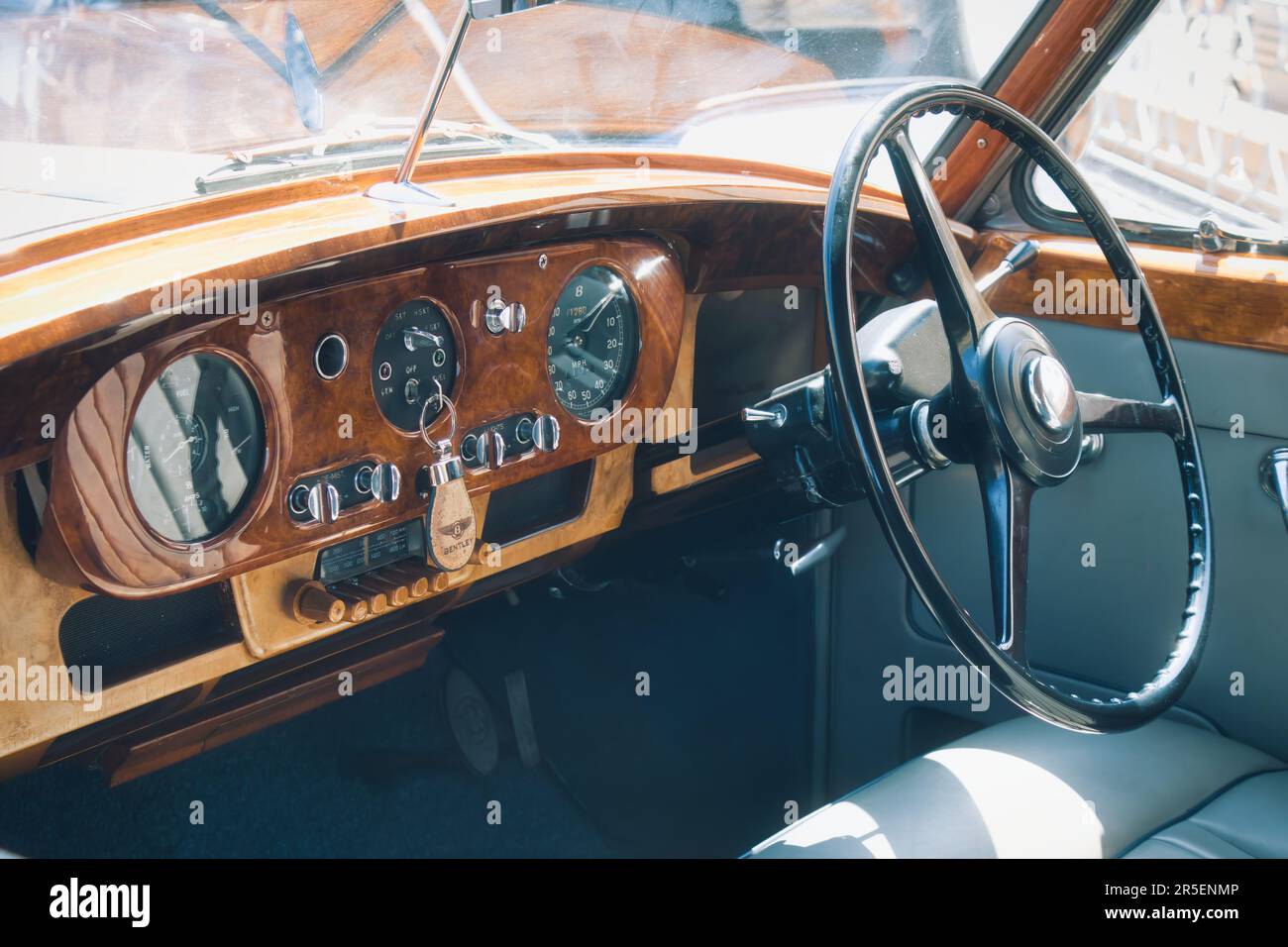 Interior of a Bentley classic car showing the gauges on the walnut dashboard and steering wheel Stock Photo