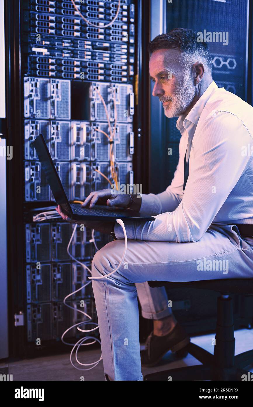 Man Useing Computer These machines have to stay running optimally. a mature man using a ...