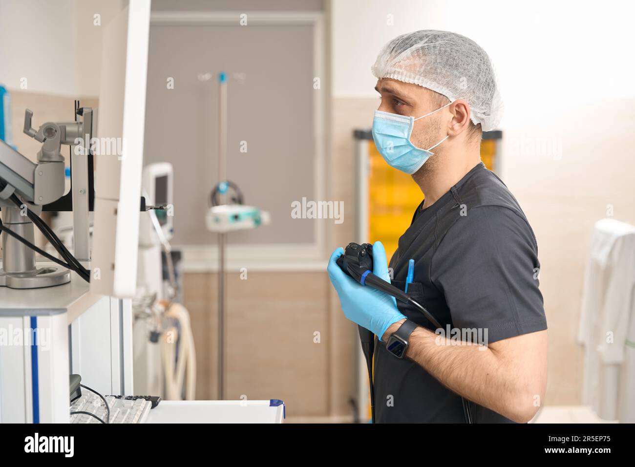 Concentrated doctor performing endoscopic ultrasound in procedure room