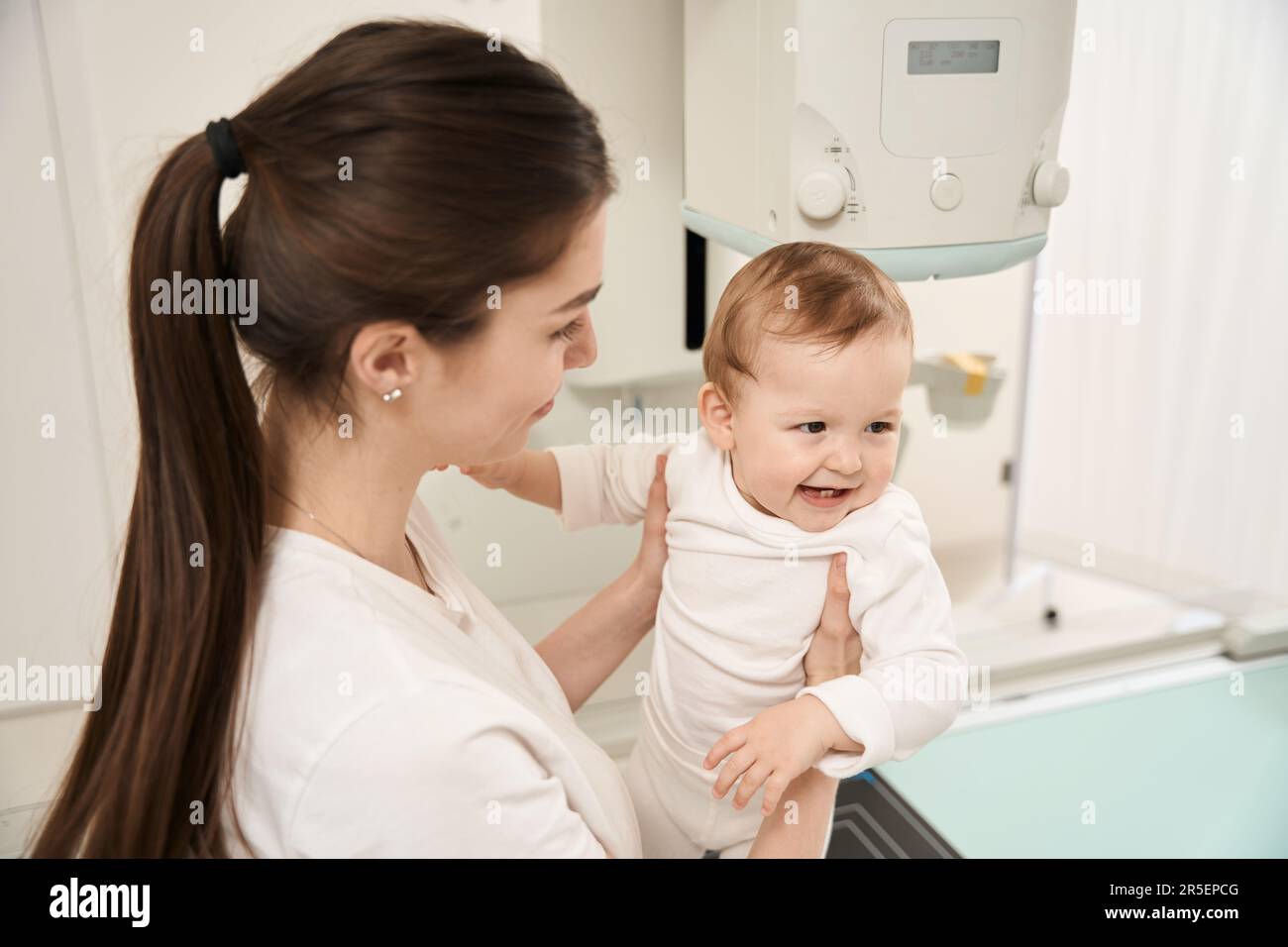 Mother getting baby ready for digital radiography Stock Photo - Alamy