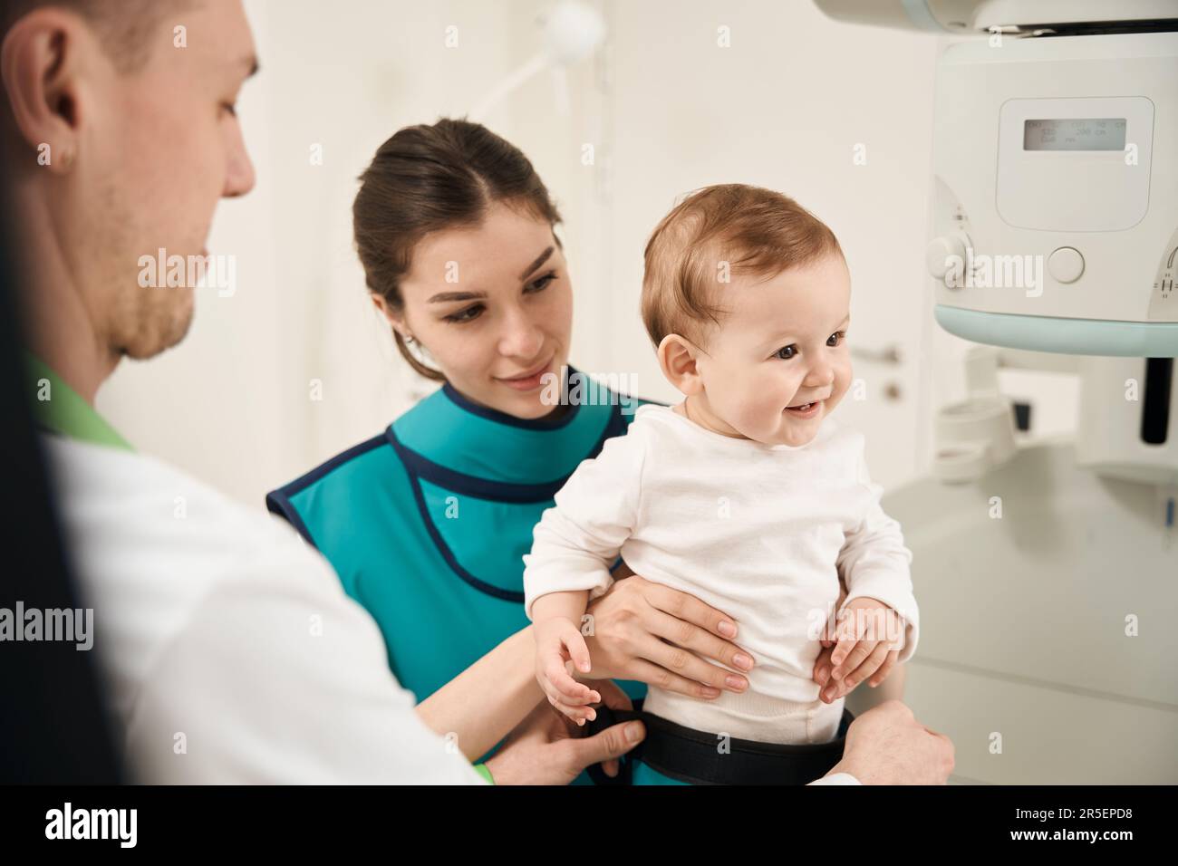 Experienced radiographer preparing little patient for diagnostic radiography Stock Photo Alamy