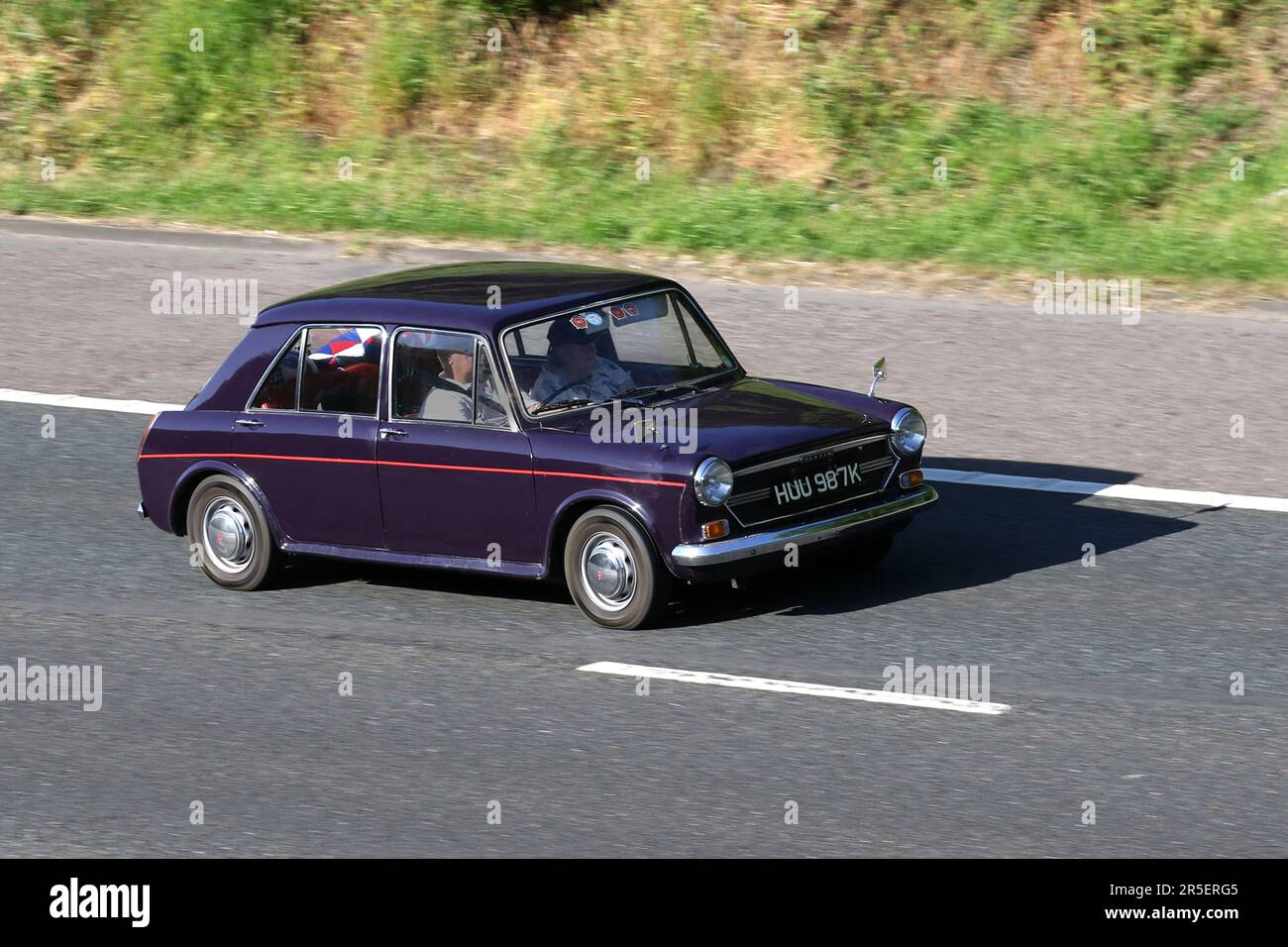1975 70s seventies Purple Mauve British AUSTIN 1275 cc; travelling at speed on the M6 motorway in Greater Manchester, UK Stock Photo