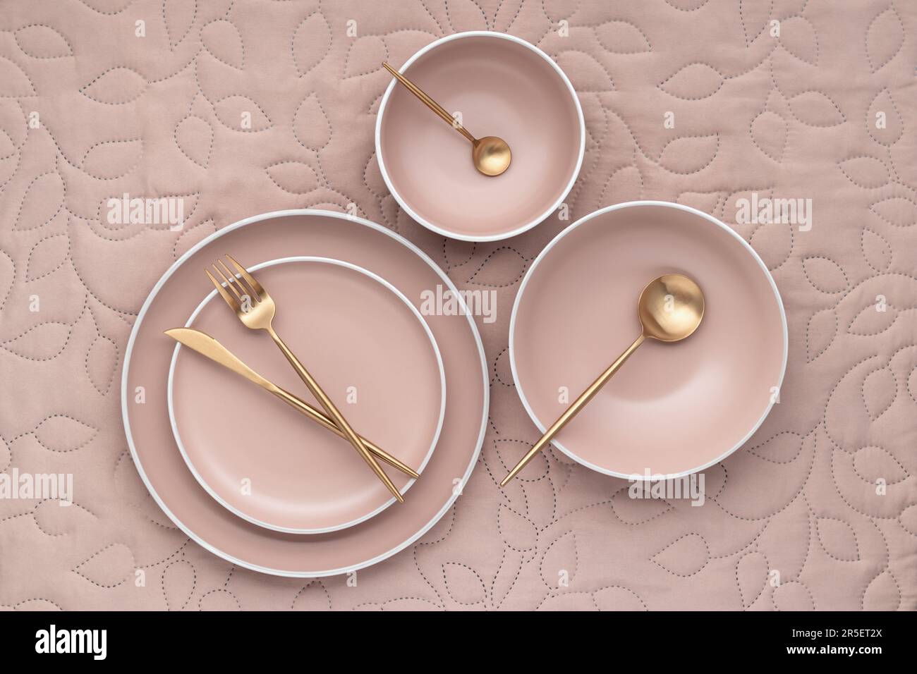 A set of round beige plates of different sizes on table, top view