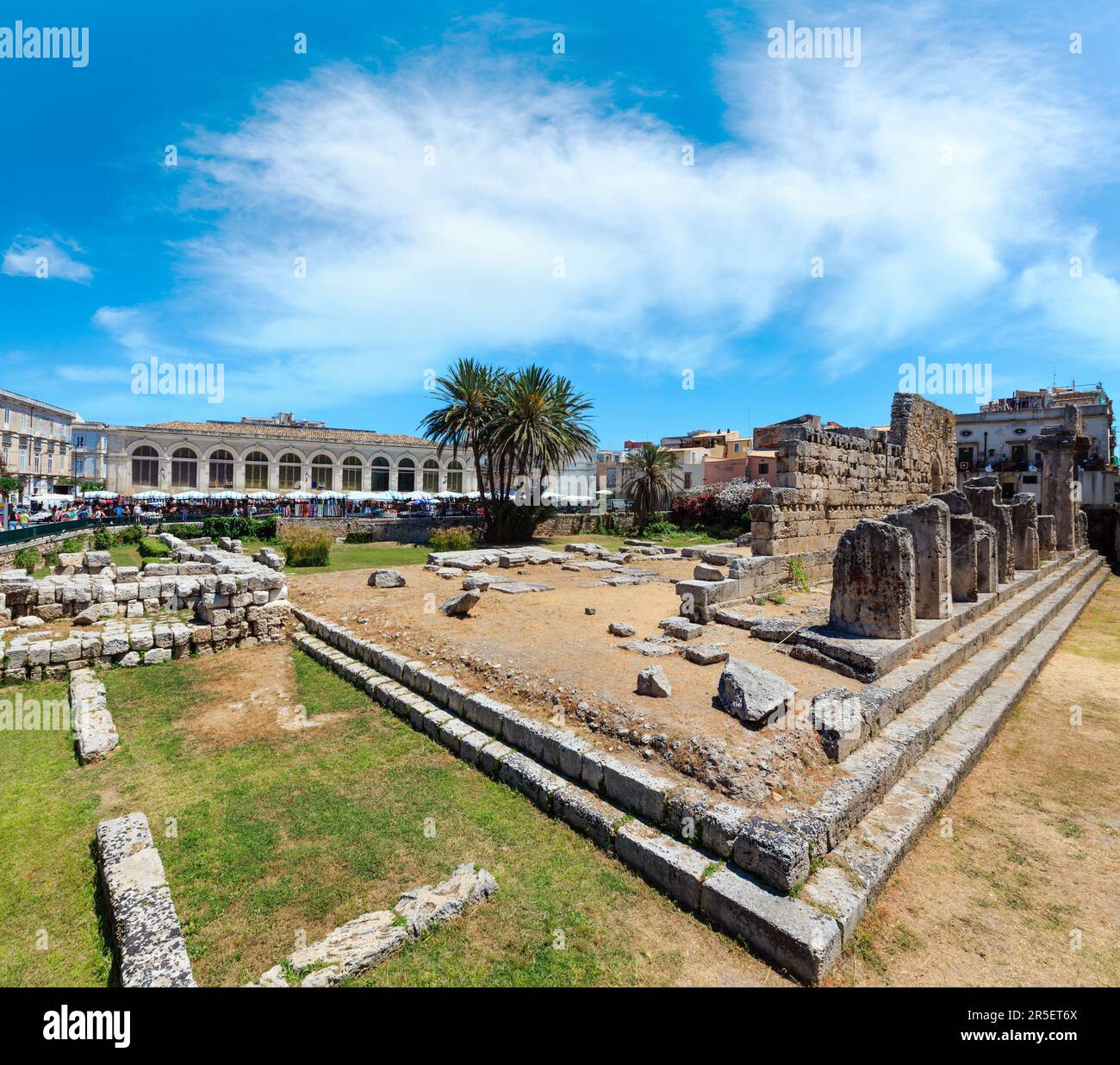 Ruins of Temple of Apollo (ancient Greek monuments on Ortygia island at city of Syracuse, Sicily, Italy). Beautiful travel photo of Sicily. People unr Stock Photo