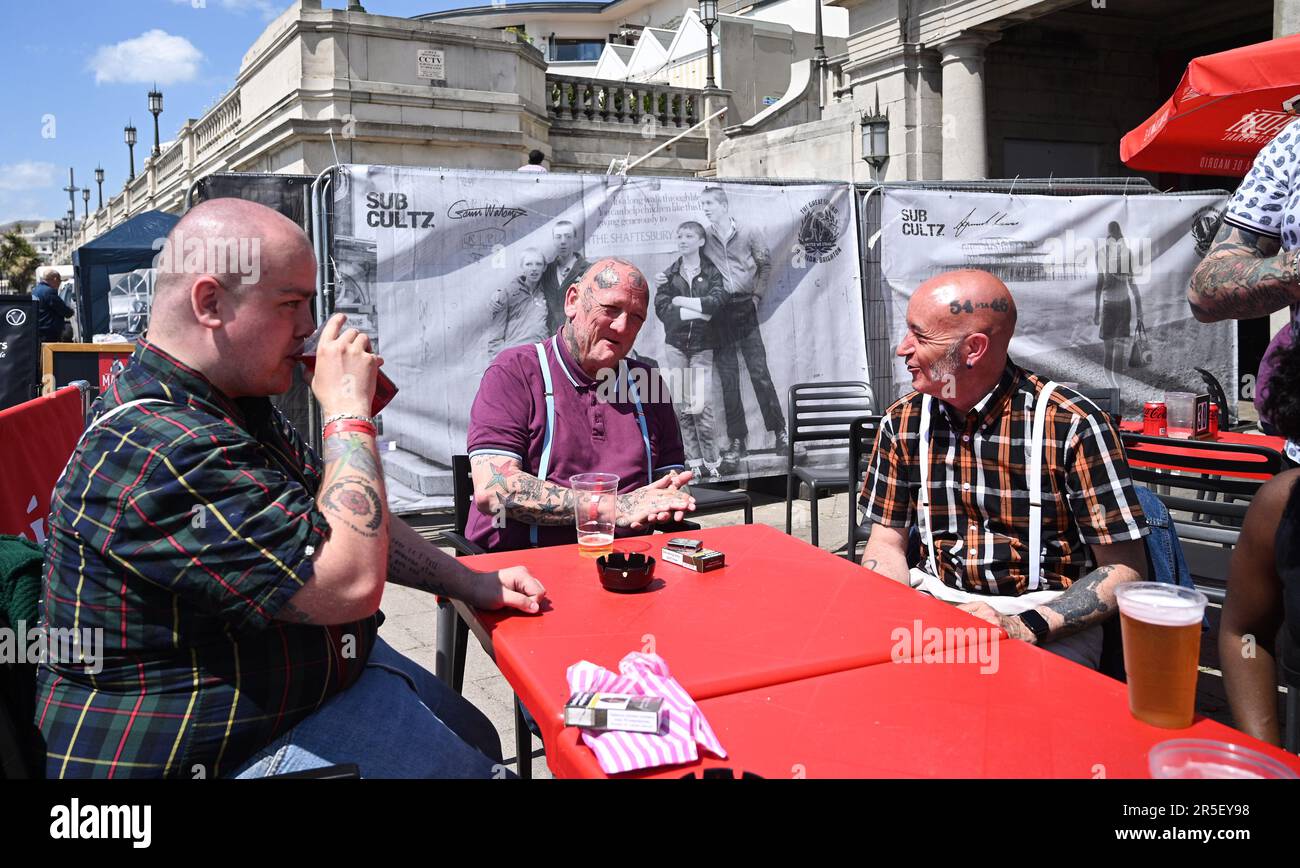 Brighton UK 3rd June 2023 - Skinheads enjoy the sunshine at the annual Great Skinhead Reunion weekend in Brighton where they gather from around the World to enjoy their music and fashion: Credit Simon Dack / Alamy Live News Stock Photo