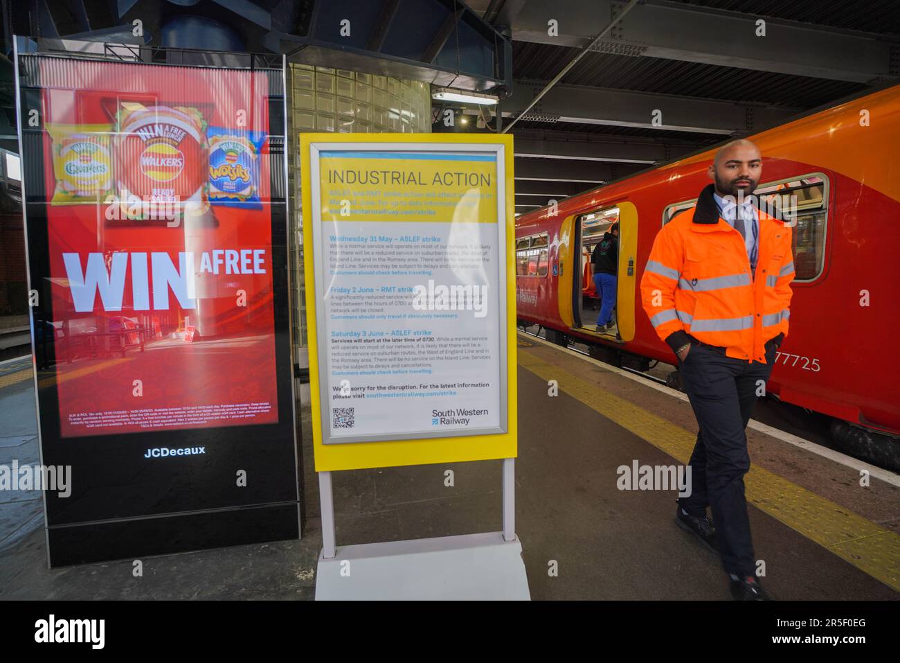 London UK. 3 June 2023 . SouthWest rail staff walk past a sign on a plfterm warning of industrial action. There are fewer services running from Waterloo station on the second day of strike action called by Aslef train drivers over pay conditions. The rail strike will cause delays and disruption to passengers and coincides with the FA Cup final at Wembley between Manchester United and Manchester City.Credit: amer ghazzal/Alamy Live News Stock Photo