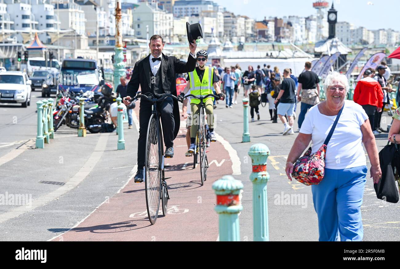 Brighton UK 3rd June 2023 - Penny Farthing cyclists enjoying a hot sunny day on Brighton seafront as good weather continues along the South Coast : Credit Simon Dack / Alamy Live News Stock Photo