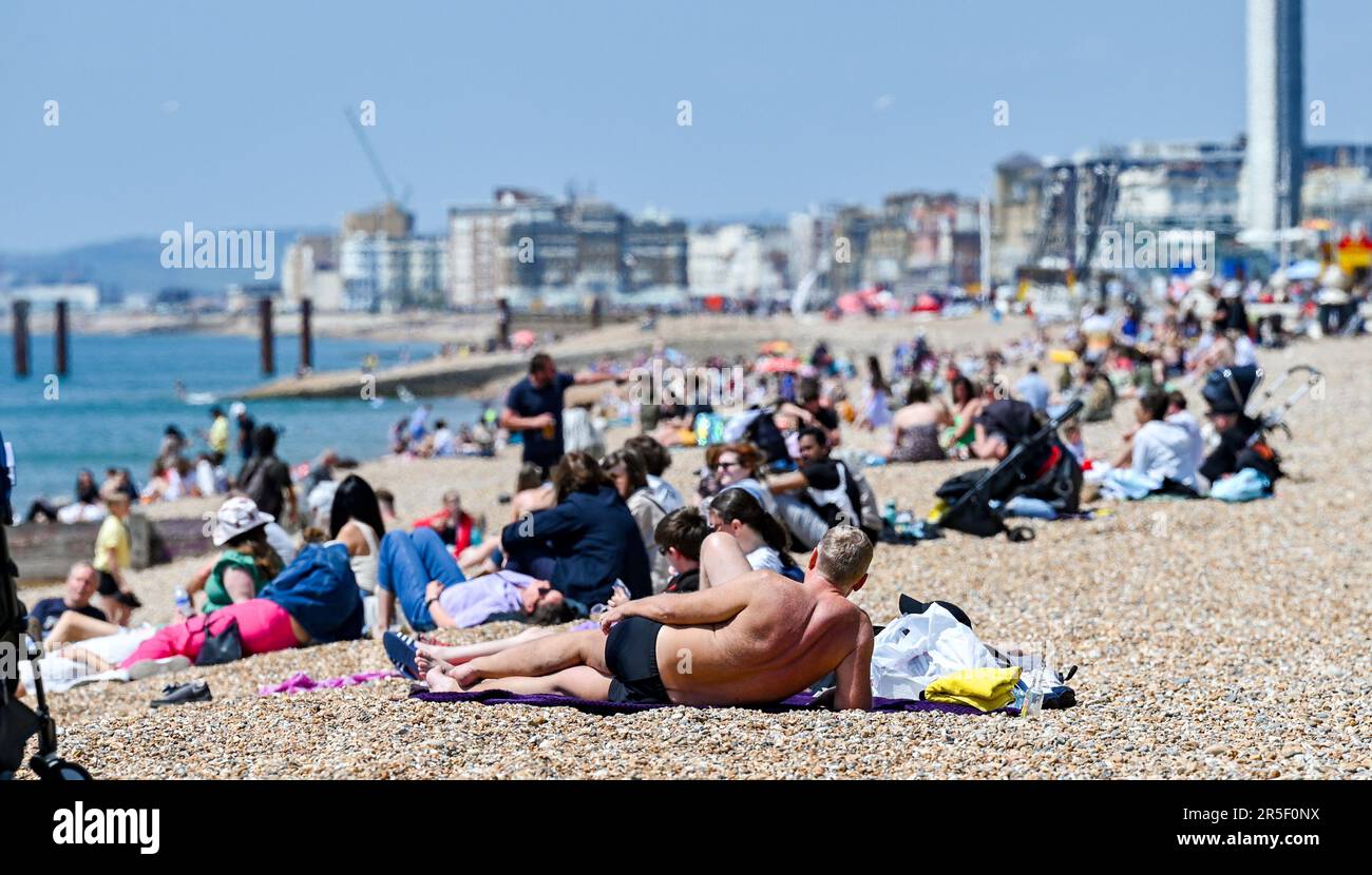 Brighton UK 3rd June 2023 - Visitors enjoy the sunshine on Brighton beach as the good weather continues along the South Coast : Credit Simon Dack / Alamy Live News Stock Photo