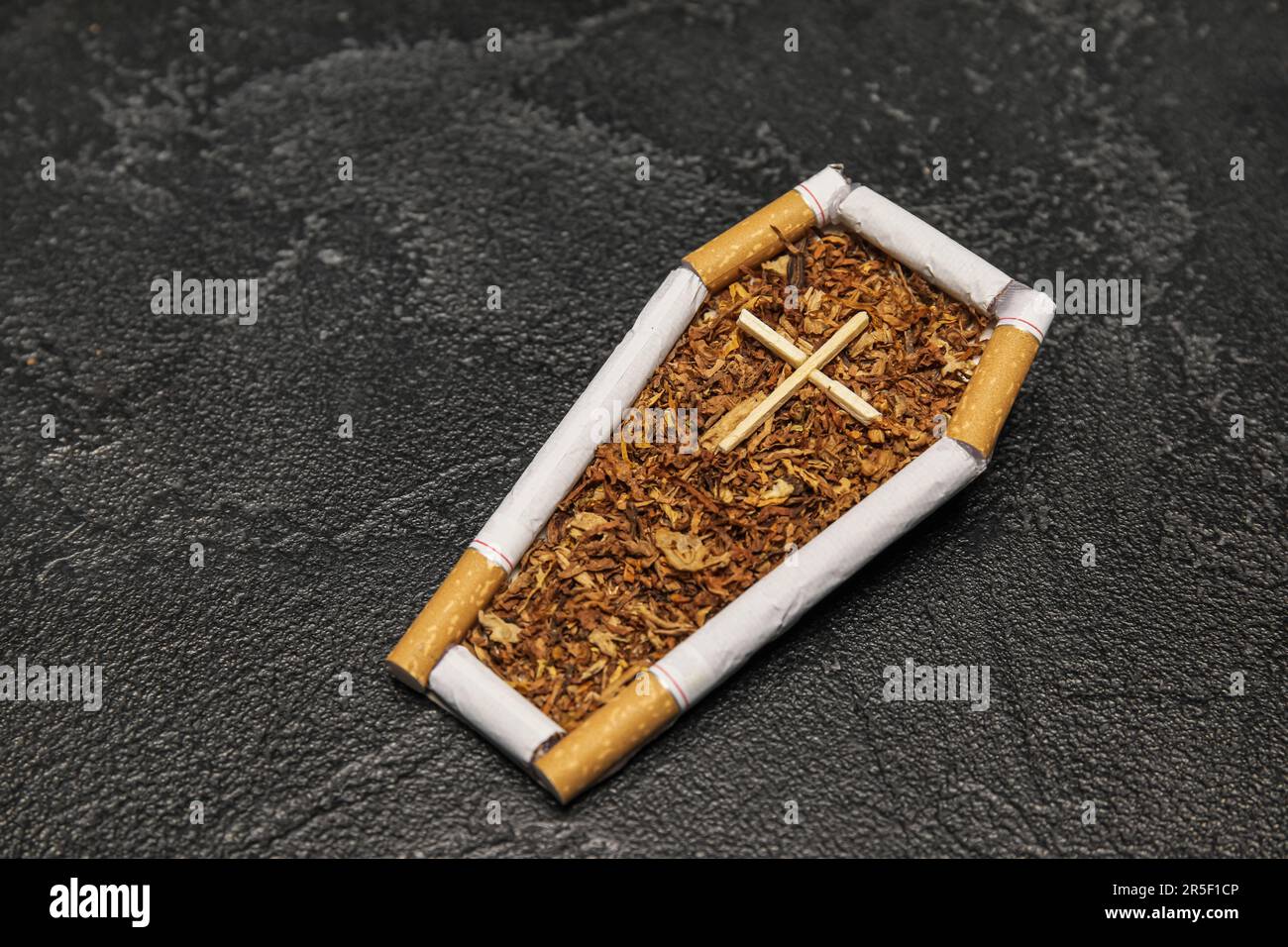 Coffin made of cigarettes and tobacco on dark background. Stop smoking  concept Stock Photo