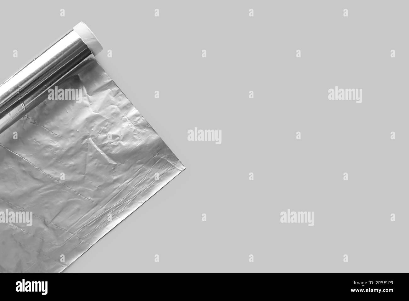 Aluminium foil roll on grey background Stock Photo Alamy