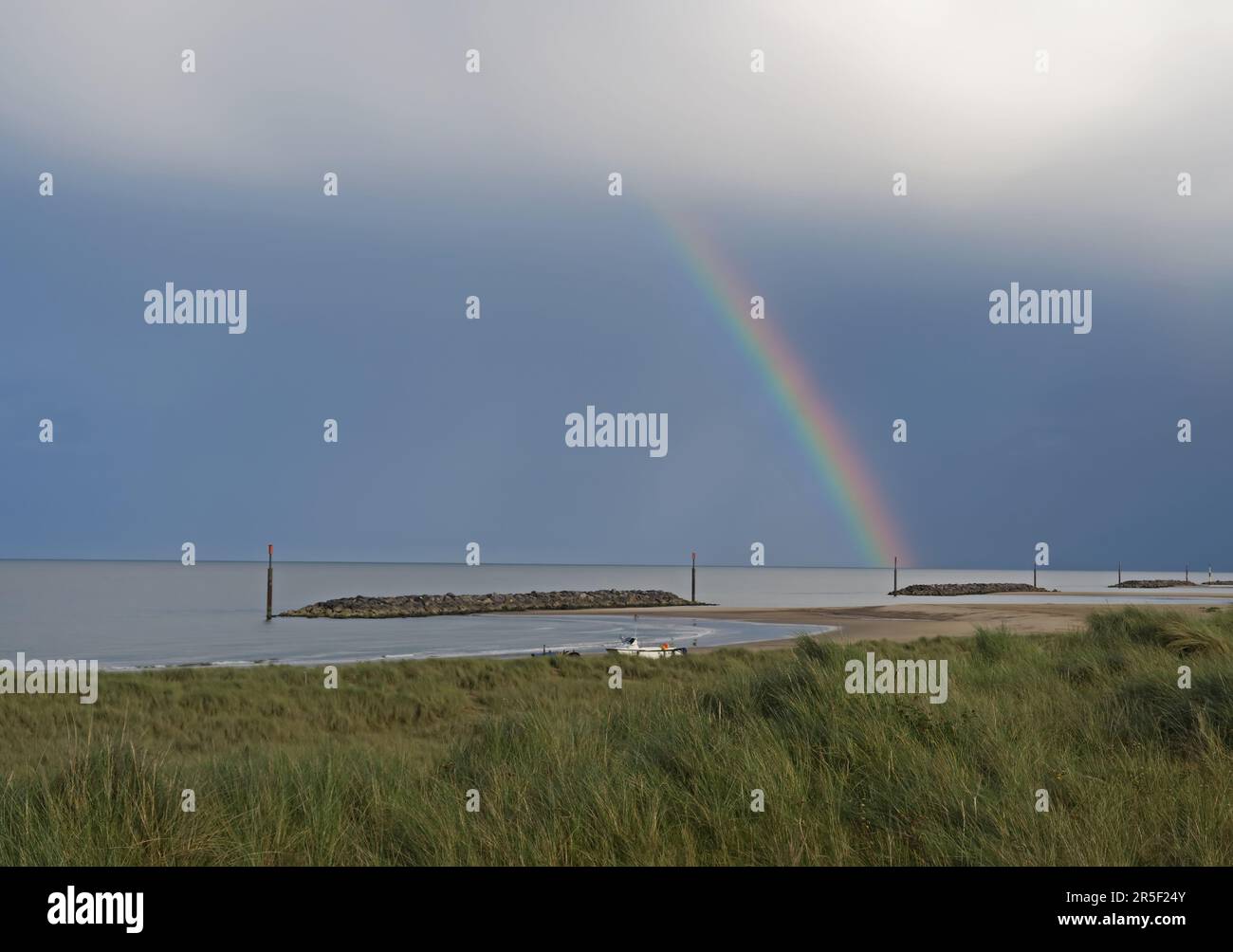 rainbow over coastal sea defence reefs  Eccles-on-Sea, Norfolk      September Stock Photo