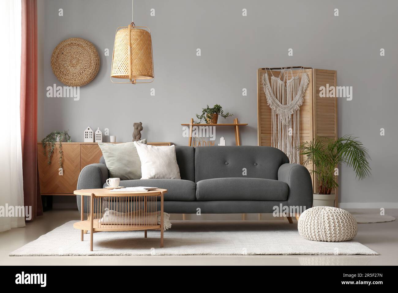 Interior of living room with grey sofa and coffee table Stock Photo - Alamy