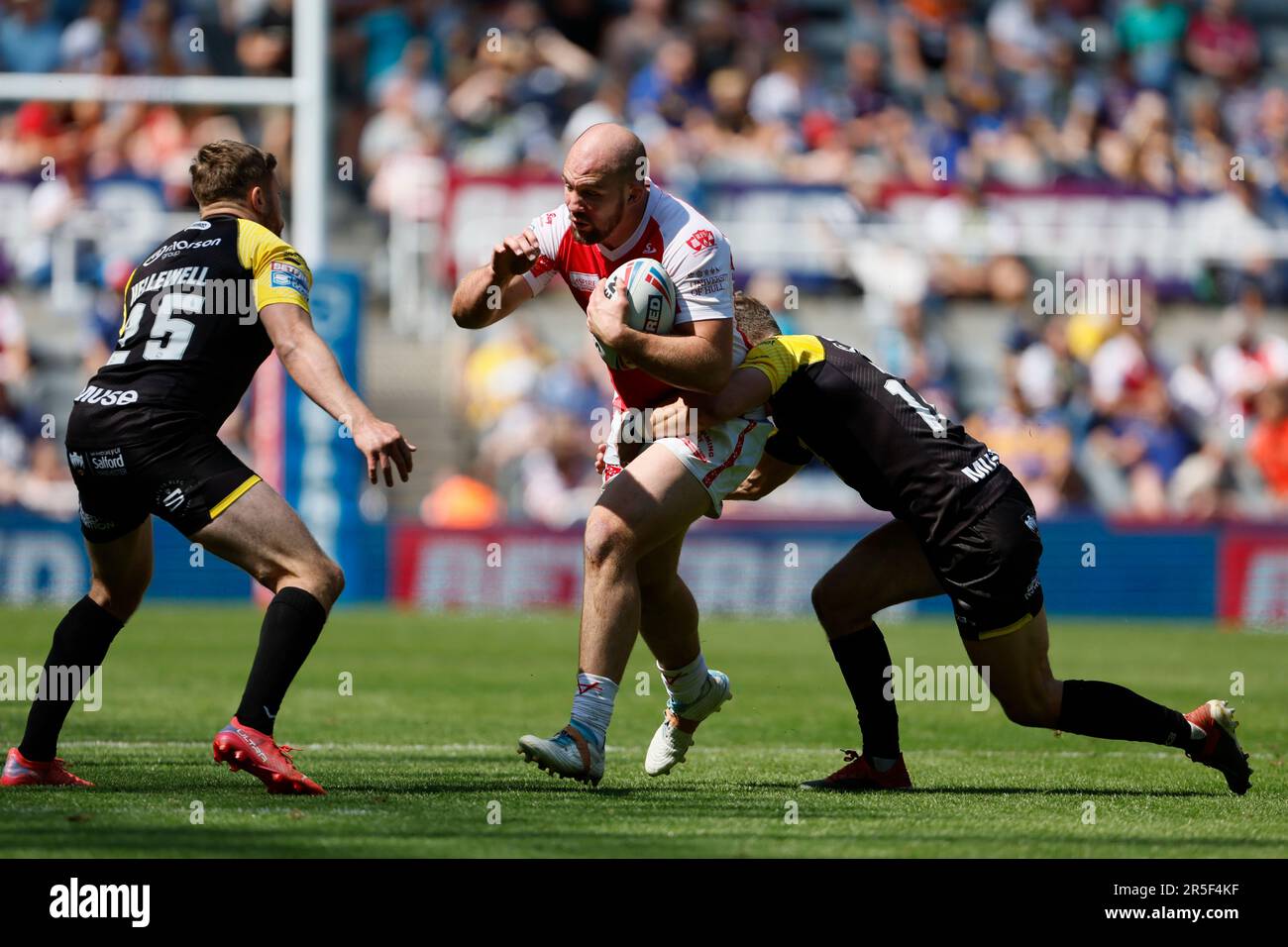 Hull KR’s George King (centre) is tackled by Salford Red Devils’ Ben Hellewell (left) and Salford Red Devils’ Chris Atkin during the Betfred Super League match at St. James' Park, Newcastle upon Tyne. Picture date: Saturday June 3, 2023. Stock Photo