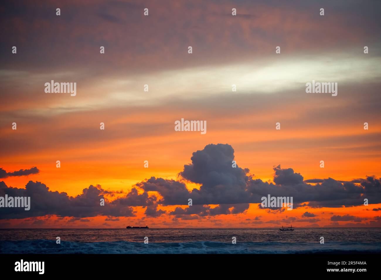 Beautiful orange sunrise wtih clouds on the sea Stock Photo - Alamy