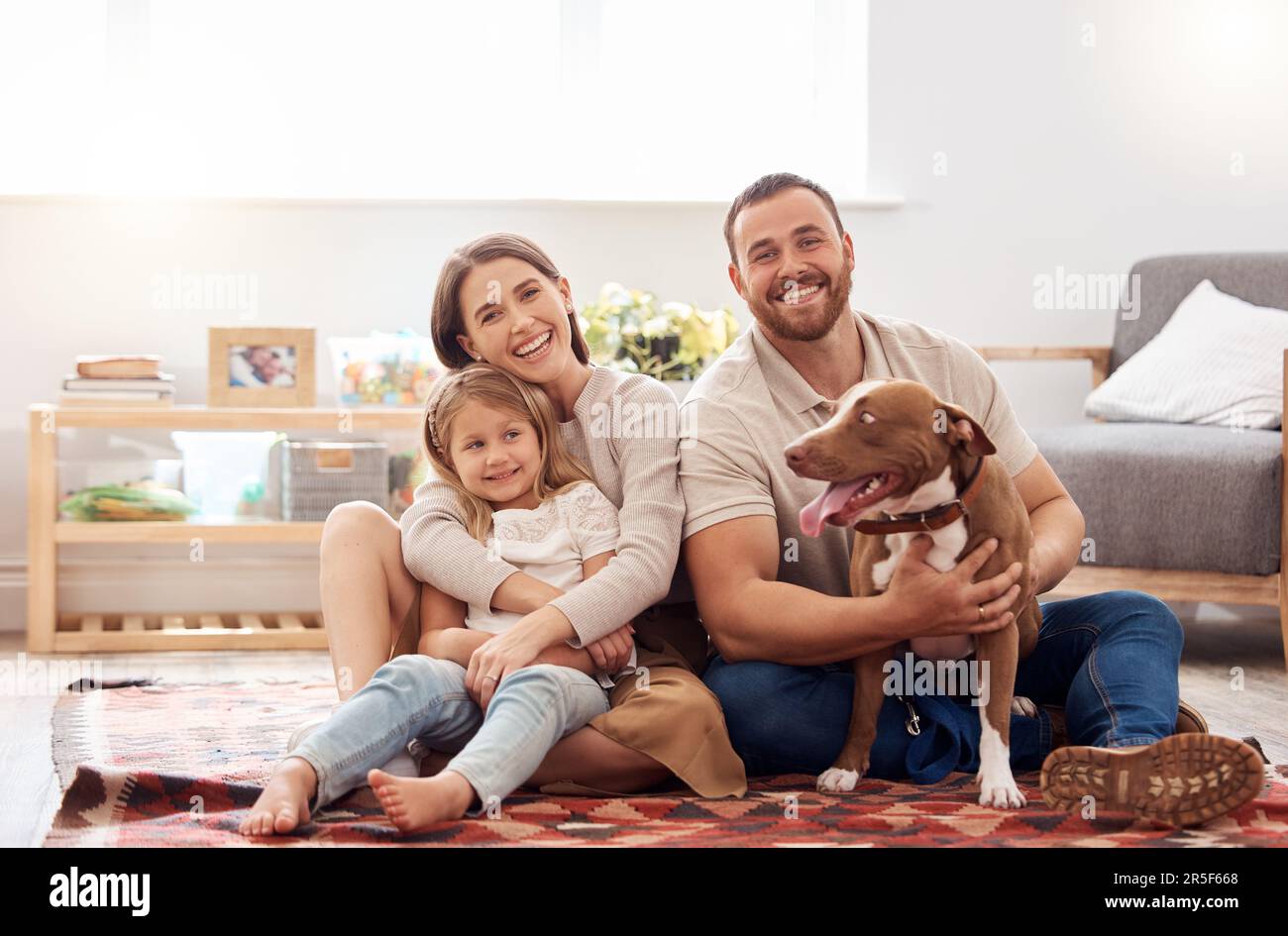 Mom, dad and portrait of kid with dog in living room for quality time ...