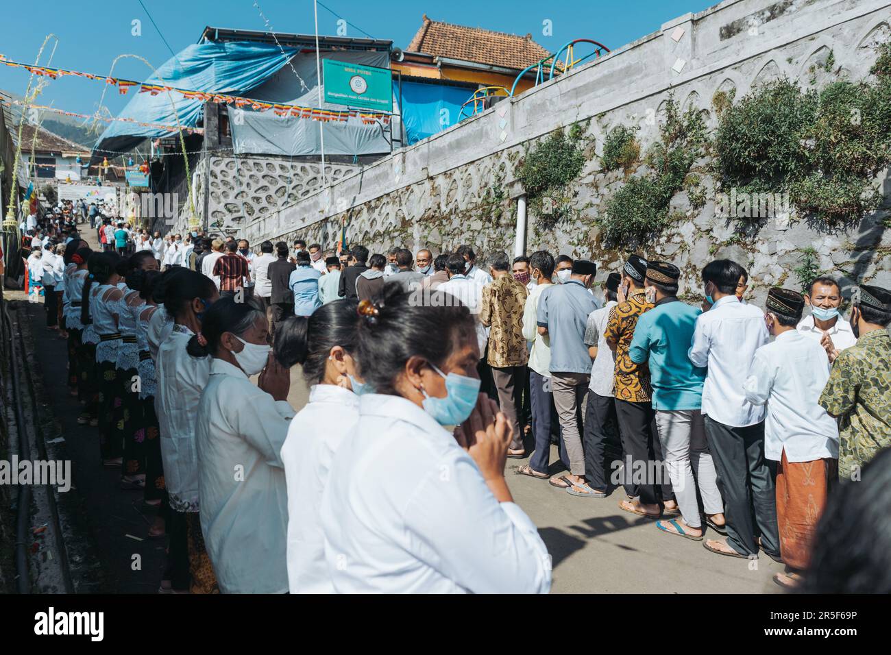 Muslim and all villagers shake hands and congratulate Buddhists who celebrate the holy day of Vesak in Thekelan village, Semarang regency, Indonesia - Stock Photo