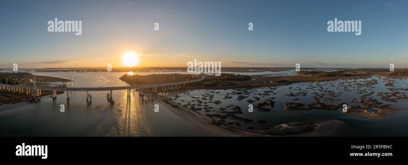 Sunset on Pinckney Island, a small nature reserve in South Carolina along with the J. Wilton Graves Bridge. Stock Photo