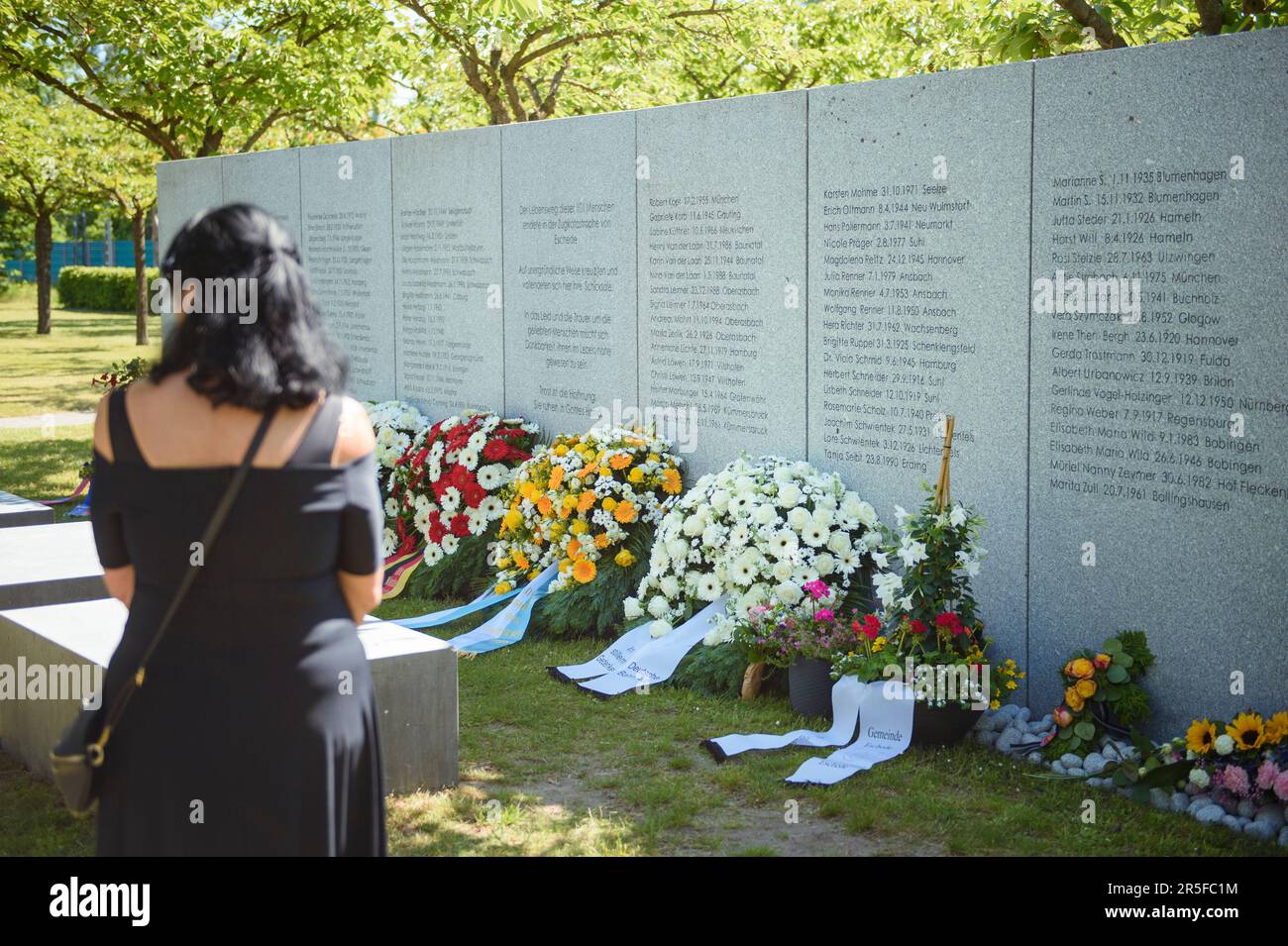 Eschede, Germany. 03rd June, 2023. A woman stands in front of the memorial plaque of the victims of the ICE accident in Eschede on the 25th anniversary. On June 03, 1998, after a wheel tire broke in Eschede, Lower Saxony, several carriages of an ICE train collide with a road bridge at a speed of 200. 101 people die. Credit: Gregor Fischer/dpa/Alamy Live News Stock Photo