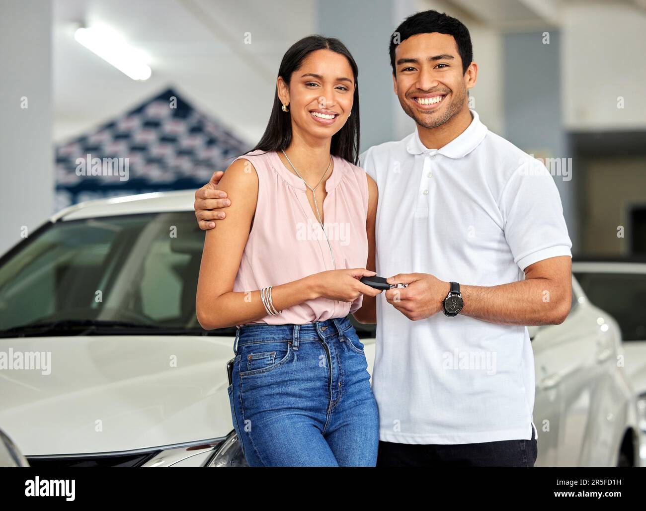 Couple at car dealership, choice and transport with key, people buy new ...