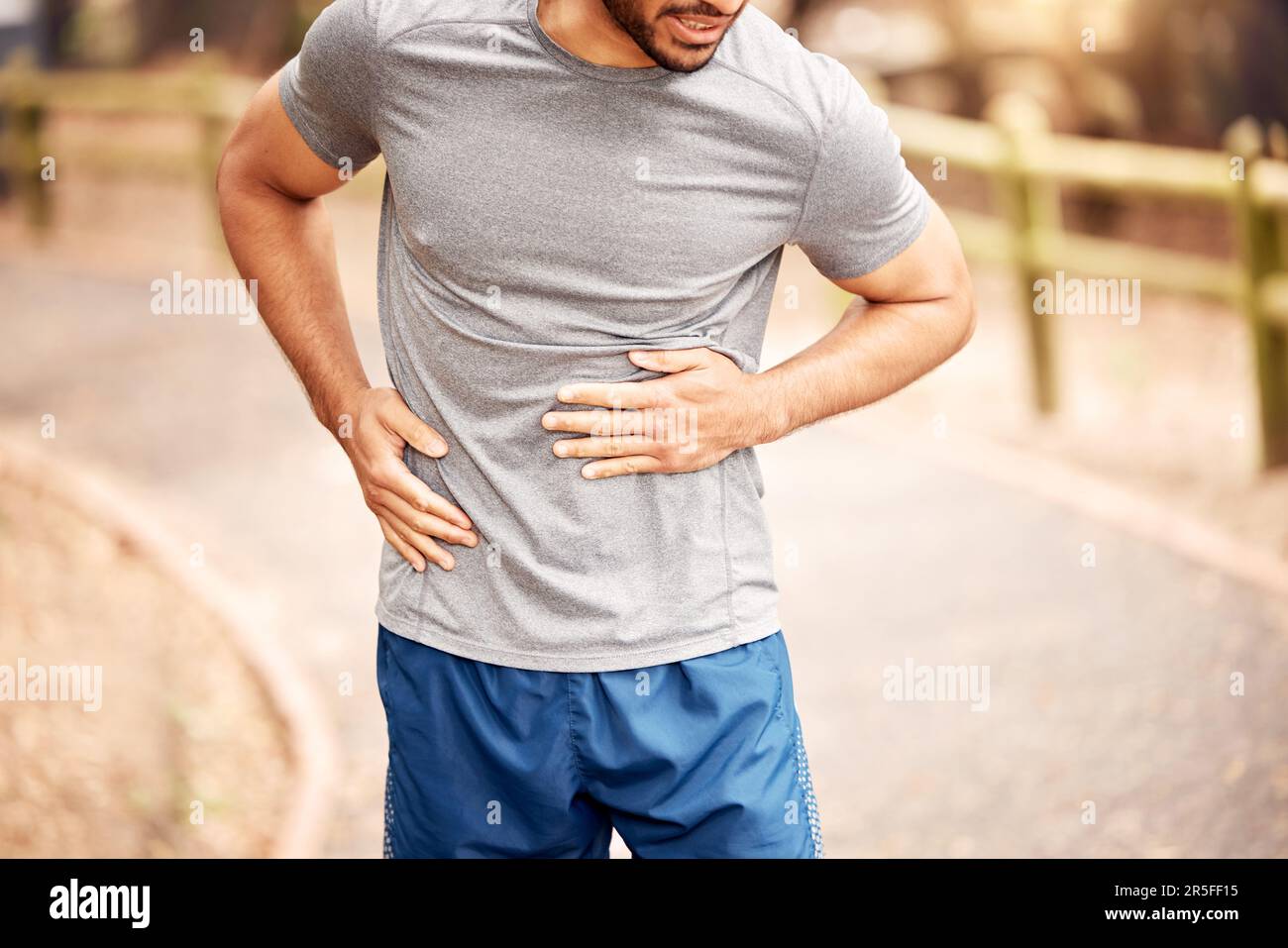Stomach pain, fitness hands and man outdoor after running, workout and