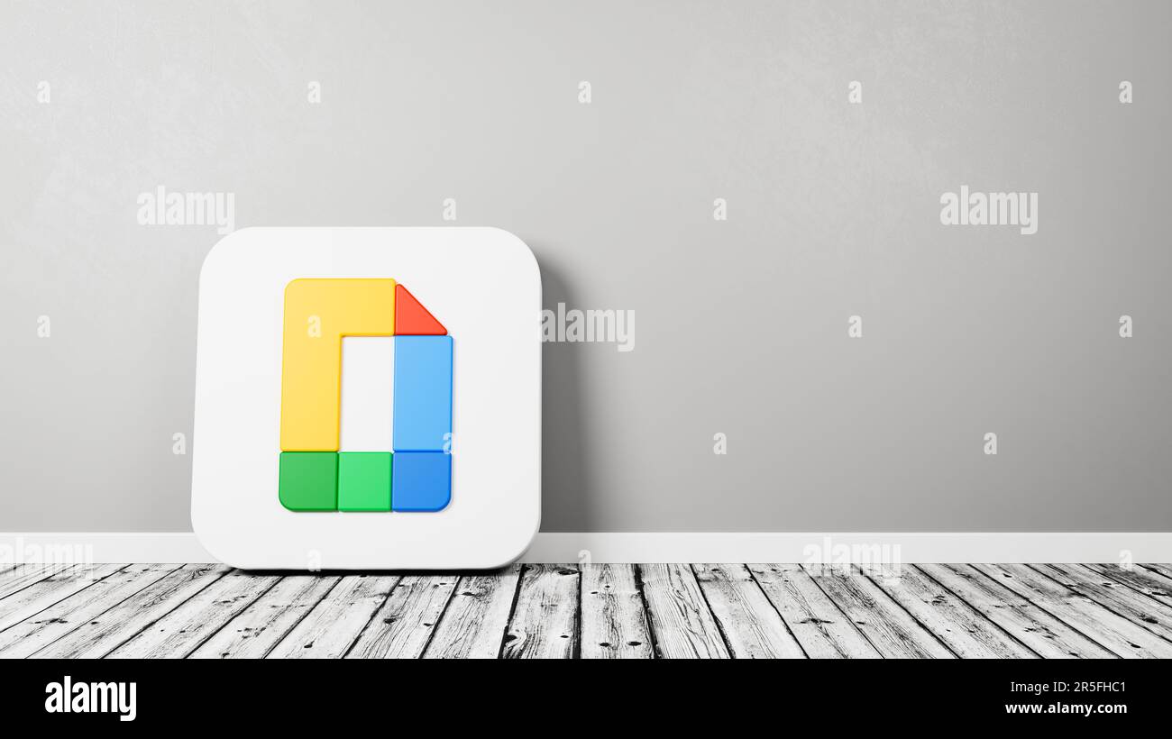 Google docs editors app icon on wooden floor against wall stock photo