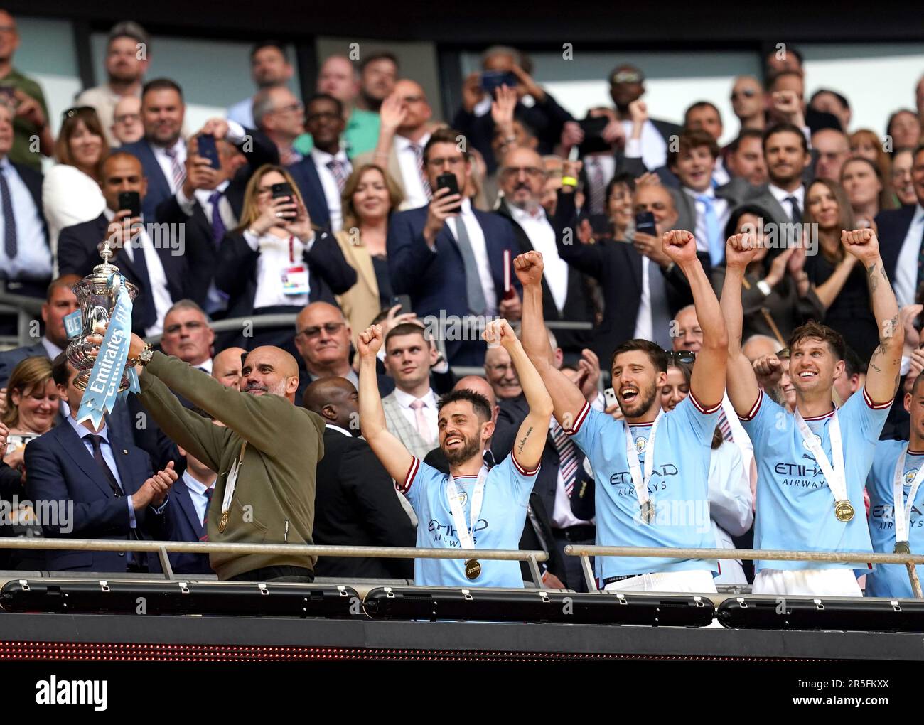 Manchester City manager Pep Guardiola lifts the Emirates FA Cup trophy