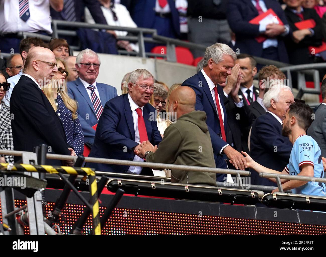 Sir Alex Ferguson greets Manchester City manager Pep Guardiola